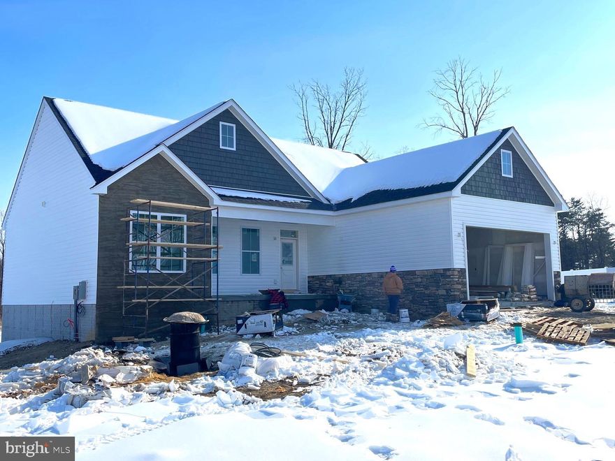 Clad in beautiful fieldstone  and shake accents, this house makes a statement on a huge corner lot.  The huge aspect doesn't end with the lot either.  Other rather huge parts include the unfinished basement, oversized deck,  primary closet and  $12,900 toward buyers closing costs.  Close on your new house in February,  This is one of our most sought-after single-level home designs is and includes an impressive list of upgraded features.

Step inside to a bright, open living area with cathedral ceilings, oversized windows, and a sunroom that fills the home with natural light and opens to a generously (over!) sized deck.  The spacious primary suite offers a tray ceiling, large walk-in closet, and a well-appointed en-suite bath with large tiled shower.  Two additional bedrooms feature upgraded ceiling heights and share a stylish hall bath. An attached 2-car garage and concrete driveway provide plenty of convenient parking.

Quality finishes come standard, including LVP flooring in the main living spaces, quartz countertops, soft-close cabinetry, and stainless steel appliances. Every home includes a 1-year builder warranty, 10-year structural warranty, and manufacturer warranties on HVAC and appliances—giving you peace of mind and protecting you from costly repairs. Buy new construction and minimize the surprises!

Located on Lot 59, the last lot on the right at the end of Sanibel Way. Floor plan and lot map are available in the listing photos. Reach out with any questions or contact your agent.