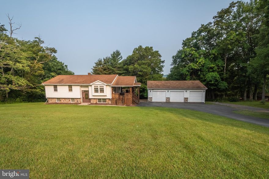 Split level home located minutes from Deep Creek Lake & Oakland, Maryland. Home has updated kitchen with granite countertops & hickory cabinets. Main level contains two bedrooms and large bath with Jacuzzi tub. Lower level has updated flooring in the family room. Also located in the lower level is an additional bedroom and laundry area. Home has new fuel oil furnace & water filtration system. Large decks on the upper level and a walk out basement with stamped concrete pad are great for entertainment or just relaxing. Home has a well and is served by public septic. There is a large detached three bay garage.  **Home currently has one bathroom because former owners converted a whole and half bathroom to closet space, but all plumbing is still intact to easily covert both back to bathrooms**