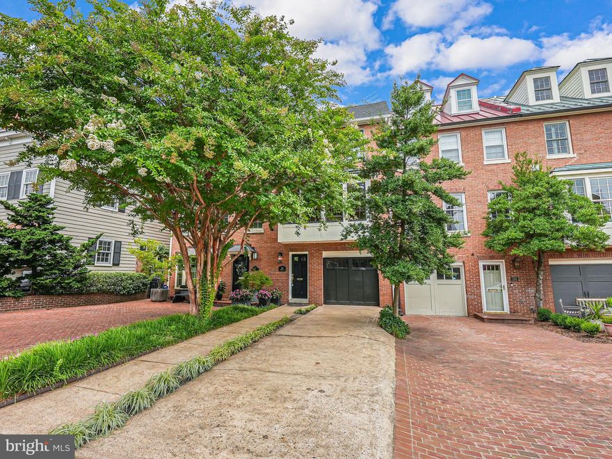 Nestled in the prestigious Pommander's Walk and just steps away from the serene Potomac River waterfront, this spectacular brick townhome epitomizes luxury and elegance. Boasting meticulously updated living space spread across four magnificent levels, this residence features 3 spacious bedrooms and 4.5 pristine baths. The grandeur of this home is immediately evident with its soaring high ceilings, exquisite hardwood floors, and sophisticated light fixtures that create a warm and inviting ambiance throughout. As you step into the gracious foyer, you are welcomed by a charming hall tree storage bench complete with hooks and cubbies, setting the tone for the refined aesthetic found throughout the home. The family room, adorned with a wood-burning fireplace and a stunning wall of built-in shelves, offers a perfect retreat for relaxation. This level also includes a convenient laundry area with a stackable washer and dryer and two elegant glass French doors leading to a private stone-paved rear patio, ideal for outdoor gatherings. Ascending to the next level, you will be captivated by the gourmet kitchen's large bay windows, allowing natural light to flood the space. This chef's dream kitchen features a grand island with leg columns, custom pendant lighting, and two-tone cabinets with chic brass hardware. The sleek matte white appliances add a contemporary touch, making this kitchen as functional as it is beautiful. Adjacent to the kitchen is an inviting dining area, which seamlessly flows into a living area complete with custom built-in shelves surrounding a wood-burning fireplace with a marble frame and a mantle. French doors from the living area open onto a spacious trek deck, perfect for alfresco dining and entertaining. The next level is dedicated to the luxurious owner's suite, featuring a generous walk-in closet and two additional closets. The lavish en-suite bath boasts a double vanity and a large shower with glass doors, offering a spa-like retreat. A second bedroom on this floor also provides ample storage with two closets, and a full bath with a vanity and tub/shower is conveniently located in the hallway. The topmost level of this splendid home is a versatile fully finished area illuminated by two skylights. This space, complete with a full bath, closet, and wet bar with a mini-fridge, can serve as a third bedroom, a home office, or a flexible living area to suit your needs. Beyond the exquisite interiors, Pommander's Walk offers an unbeatable location in Old Town Alexandria. Residents enjoy easy access to the vibrant boutiques, dining, and nightlife along King Street. Daily conveniences such as coffee shops, the renowned Balducci's food market, and various eateries are just a short stroll away. With downtown DC and Reagan National Airport within a quick drive, and the King Street Metro Station nearby, this home's location is truly unparalleled. Experience the epitome of sophisticated urban living in this magnificent Pommander's Walk townhome, where timeless elegance meets modern convenience.