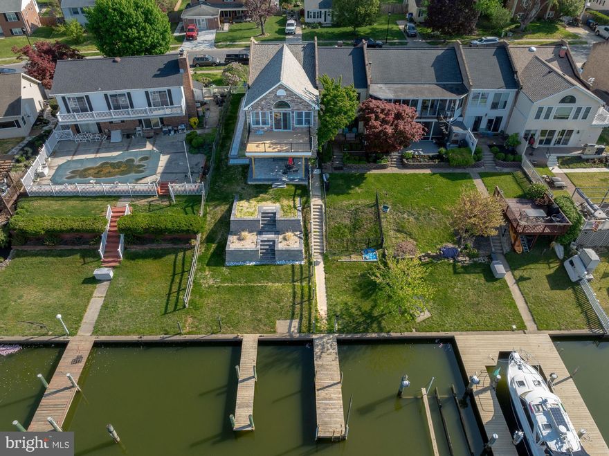 Rare Waterfront End-of-Group Townhome offering 2 bedrooms, 2 full bathrooms, and just under 2,500 square feet of finished living space in the highly sought-after water-oriented community of Rumsey Island.

Step into the main level of this massive townhome where the open layout and direct water views will immediately capture your attention. Featuring laminate wood flooring, ample recessed lighting, and impressive crown molding, this versatile space is ideal for entertaining friends and family after a day on the water. Use it as a large recreation room, game room, or explore the potential to create a spacious primary bedroom overlooking the water. The main level also includes a full bathroom, storage closet, under-stair storage, and a utility room with a full-size washer and dryer plus laundry sink.

The exterior is truly the showpiece of the home, offering approximately 36 feet of waterfrontage. The seller spared no expense with a brand-new professionally engineered two-tier stamped retaining wall system with soil stabilization, all-new Belgard patio area and walkways, a brand-new composite deck, and a brand-new roof with architectural shingles, gutters, and flashing. Perfectly positioned on a cove, owners enjoy two piers, including one shared pier, with approximately 4 to 5 feet of water depth near the piers. Enjoy endless waterfront activities including powerboats, jet skis, kayaks, paddle boats, paddleboarding, and more.

The spacious, light-filled upper level is the perfect place to unwind after a day on the water. It features an open kitchen with ample cabinet space, a convenient dining area, and a large great room with vaulted ceilings, recessed lighting, and breathtaking water views. Step outside to the brand-new composite deck and take in beautiful sunsets. This level also offers two bedrooms, one full bathroom, and a hall linen closet.

Additional highlights include a water heater replaced in 2023, private 2-car parking pad, front porch sitting area, front porch storage shed, side yard shed, stainless steel double-door refrigerator with water dispenser and ice maker, pull-down attic stairs, and electric service on the pier.

Don’t miss this rare opportunity to own a waterfront townhome in the close-knit community of Rumsey Island where neighbors truly look out for one another. Be sure to check out the impressive 3D virtual tour and schedule your private showing today. This one will not last long.