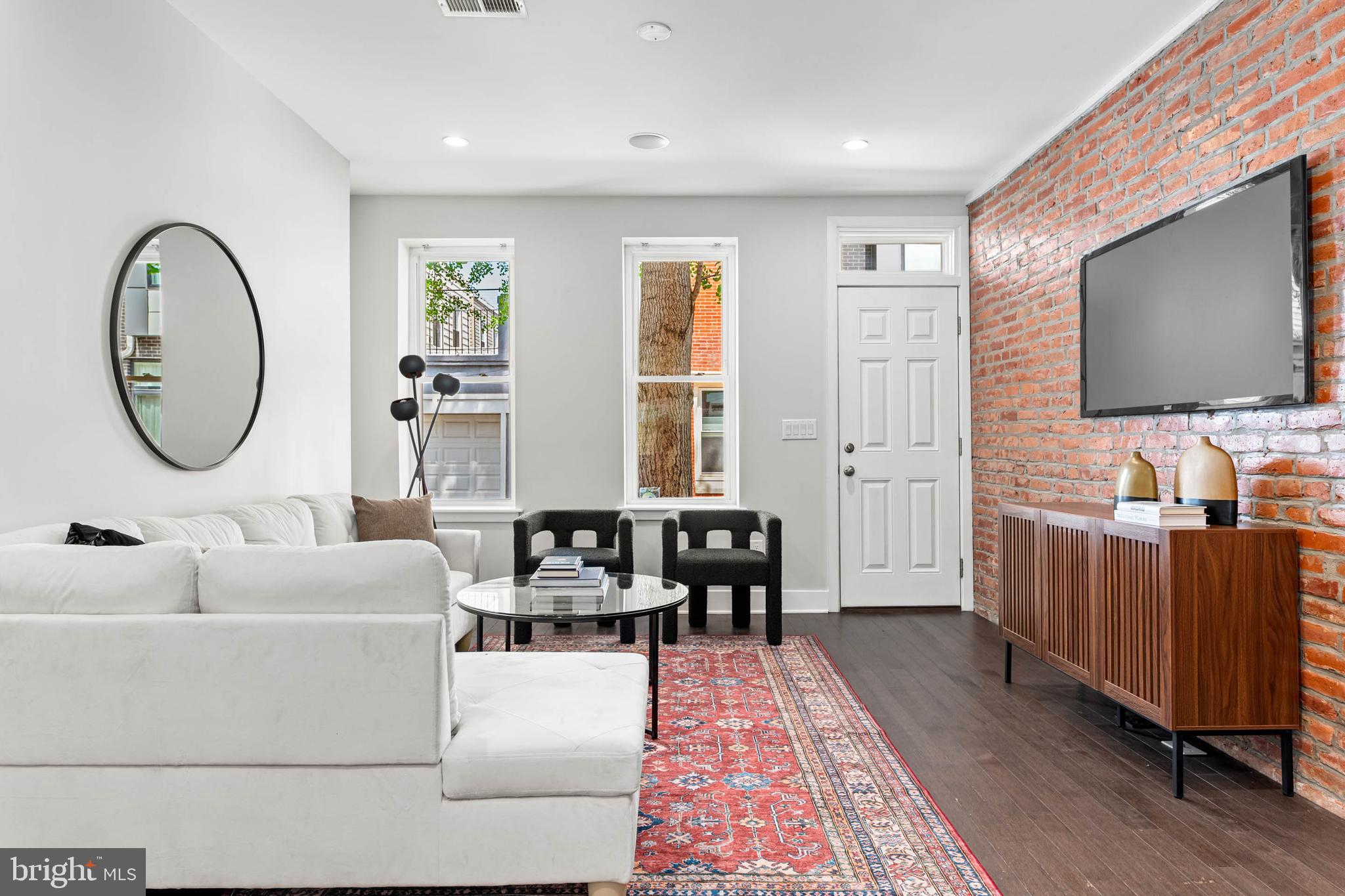 Stylish Point Breeze Gem with Finished Basement, Backyard Oasis & Tax Abatement!
Discover sophisticated urban living in this stunning 2-bedroom, 2.5-bathroom Point Breeze home, complete with a finished lower level and significant (and valuable) time remaining on its tax abatement!
Step inside and be captivated by the seamless blend of contemporary finishes and thoughtful design. The open-concept main level is perfect for entertaining, featuring gleaming hardwood floors, elegant recessed lighting with in-ceiling speakers, and character-rich exposed brick walls. A striking custom-designed open staircase with iron railings anchors the space, while large windows bathe the living and dining areas in natural light.
The flexible floor plan includes stylish built-in shelving, ready for your personal touch. Flow effortlessly into the modern, well-appointed kitchen, boasting sleek stainless steel appliances, a timeless white subway tile backsplash, and ample counter space for culinary creativity, including convenient counter seating perfect for casual meals. Adding to the main level's convenience is a stylish powder room located just off the kitchen. From the kitchen, sliding glass doors lead to a spacious private backyard – your personal retreat for sunny afternoons and al fresco dining.
Upstairs, find two bright and airy bedrooms, each offering generous closet space. The beautifully updated hall bathroom features a chic dual vanity, contemporary tiled flooring, and a relaxing shower/tub combination surrounded by custom subway tile.
Need more space? The fully finished lower level provides valuable extra living area, complete with a full bathroom and dedicated laundry zone – ideal for a media room, home office, gym, or guest suite.
Renovated prior to the current owner's purchase in 2019, this home offers peace of mind with newer plumbing, HVAC, windows, a stunning kitchen and bathrooms, and a roof that's only a few years old. Situated on a charming street just a block from vibrant Wharton Square Park, you'll love being in the heart of the thriving Point Breeze neighborhood.
Don't miss this incredible opportunity to own a move-in ready home with modern amenities and financial benefits. Schedule your showing today!
Notice: floor plans provided are a helpful visual guide and offered as a courtesy. Please note that all dimensions and square footage are approximate; we encourage you to personally verify all measurements to ensure they meet your needs. Prospective buyers are advised to independently verify all property tax information, including but not limited to current tax rates, assessment values, and the status of any tax abatements or exemptions.