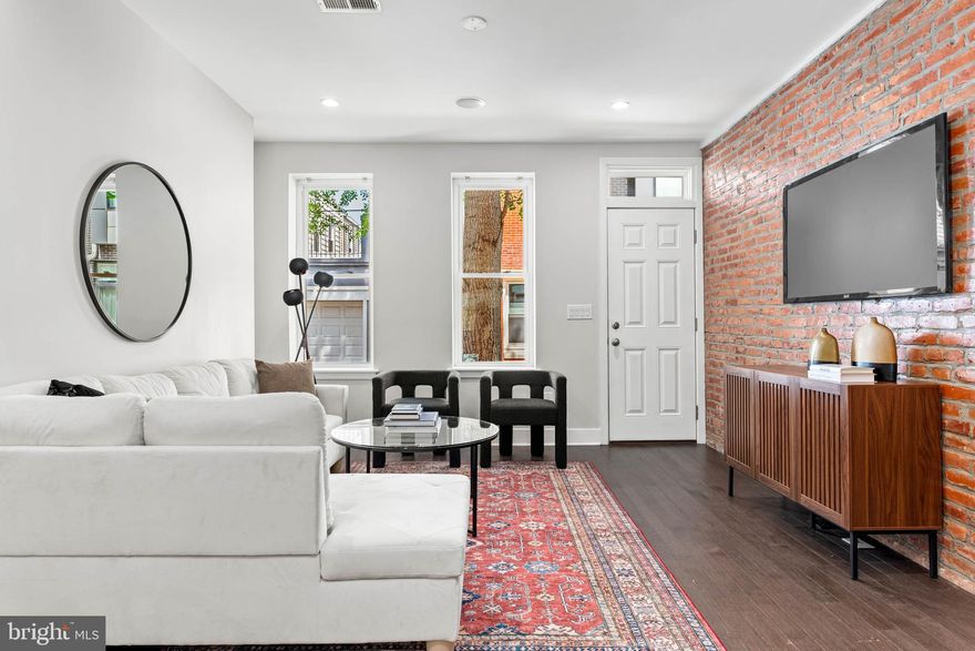 Stylish Point Breeze Gem with Finished Basement, Backyard Oasis & Tax Abatement!

Discover sophisticated urban living in this stunning 2-bedroom, 2.5-bathroom Point Breeze home, complete with a finished lower level and significant (and valuable) time remaining on its tax abatement!

Step inside and be captivated by the seamless blend of contemporary finishes and thoughtful design. The open-concept main level is perfect for entertaining, featuring gleaming hardwood floors, elegant recessed lighting with in-ceiling speakers, and character-rich exposed brick walls. A striking custom-designed open staircase with iron railings anchors the space, while large windows bathe the living and dining areas in natural light.

The flexible floor plan includes stylish built-in shelving, ready for your personal touch. Flow effortlessly into the modern, well-appointed kitchen, boasting sleek stainless steel appliances, a timeless white subway tile backsplash, and ample counter space for culinary creativity, including convenient counter seating perfect for casual meals. Adding to the main level's convenience is a stylish powder room located just off the kitchen. From the kitchen, sliding glass doors lead to a spacious private backyard – your personal retreat for sunny afternoons and al fresco dining.

Upstairs, find two bright and airy bedrooms, each offering generous closet space. The beautifully updated hall bathroom features a chic dual vanity, contemporary tiled flooring, and a relaxing shower/tub combination surrounded by custom subway tile.

Need more space? The fully finished lower level provides valuable extra living area, complete with a full bathroom and dedicated laundry zone – ideal for a media room, home office, gym, or guest suite.

Renovated prior to the current owner's purchase in 2019, this home offers peace of mind with newer plumbing, HVAC, windows, a stunning kitchen and bathrooms, and a roof that's only a few years old. Situated on a charming street just a block from vibrant Wharton Square Park, you'll love being in the heart of the thriving Point Breeze neighborhood.

Don't miss this incredible opportunity to own a move-in ready home with modern amenities and financial benefits. Schedule your showing today!

Notice: floor plans provided are a helpful visual guide and offered as a courtesy. Please note that all dimensions and square footage are approximate; we encourage you to personally verify all measurements to ensure they meet your needs. Prospective buyers are advised to independently verify all property tax information, including but not limited to current tax rates, assessment values, and the status of any tax abatements or exemptions.