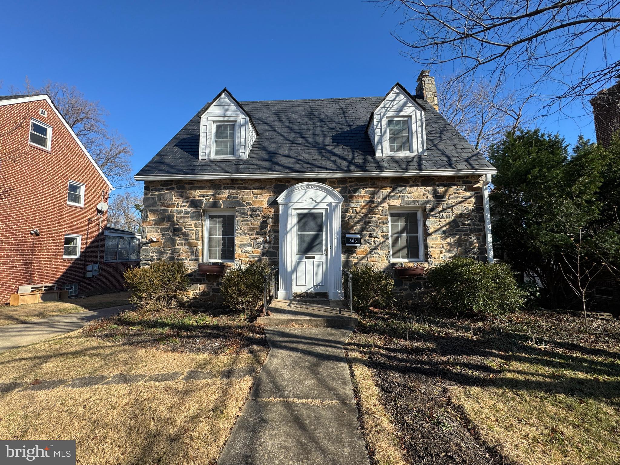 ****Open House canceled for Sunday. ***Absolutely charming stone colonial near Catonsville in Kensington community convenient to shopping, beltway, Ft Meade, BWI airport only 10 minutes away. Gleaming oak hardwood floors throughout, gothic archways between rooms, and more. Formal living room expresses a stone fireplace with full mantle, and sconce lighting above. Formal dining room with lighted ceiling fan. Good sized kitchen with extra cabinets, and Corean counter tops and 12 inch ceramic tile flooring. A BONUS sunroom perfect for seasonal relaxation. 3 lovely bedrooms with dormers and nice closets and a full bath adorn the upper level. The lower level has a retro Knotty Pine walled recreation room with a hide-away closet or wine storage room, and a large utility room with lots of storage, a full bath, laundry facilities and a walk-up to the rear yard.
The driveway is extended to the rear yard with a drive through carport and a 1 car garage. Lots of parking. The fenced rear yard offers beautiful landscaping and hardscaping with a brick patio. Extras: Slate roof was replaced in 2014. Gas water heater 2013. Gas boiler maintained annually. Windows were replace with double pane throughout. The story is that this home was built by the developer of Kensington and was very well maintained by all the owners. Home being sold "as is". Great price!