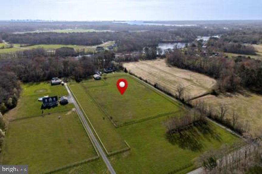 Welcome to 12740 Jarvis Road!  A rare waterfront retreat set on 10.75 acres in Bishopville, MD. This spacious 4-bedroom, 3-bath home offers the perfect blend of privacy, open land, and direct water access.
Enjoy endless outdoor possibilities with a beautiful pasture stretching across the front of the property, ideal for horses, hobby farming, or simply taking in the peaceful surroundings (a new tin roof was put on the barn in 2023).  Out back, take advantage of your private waterfront lifestyle complete with a boat lift—perfect for boating, fishing, and exploring the nearby waterways. New boards on the dock in 2024 and new boat lift in 2025.
The home offers generous living space with a functional layout suited for both everyday living and entertaining.  Brand new HVAC System and a new septic pump installed 2025.  A detached 2-car garage provides ample storage for vehicles, equipment, or recreational gear.
Whether you’re looking for a full-time residence, weekend escape, or a property with room to grow, this unique waterfront estate delivers space, versatility, and the best of coastal country living.
