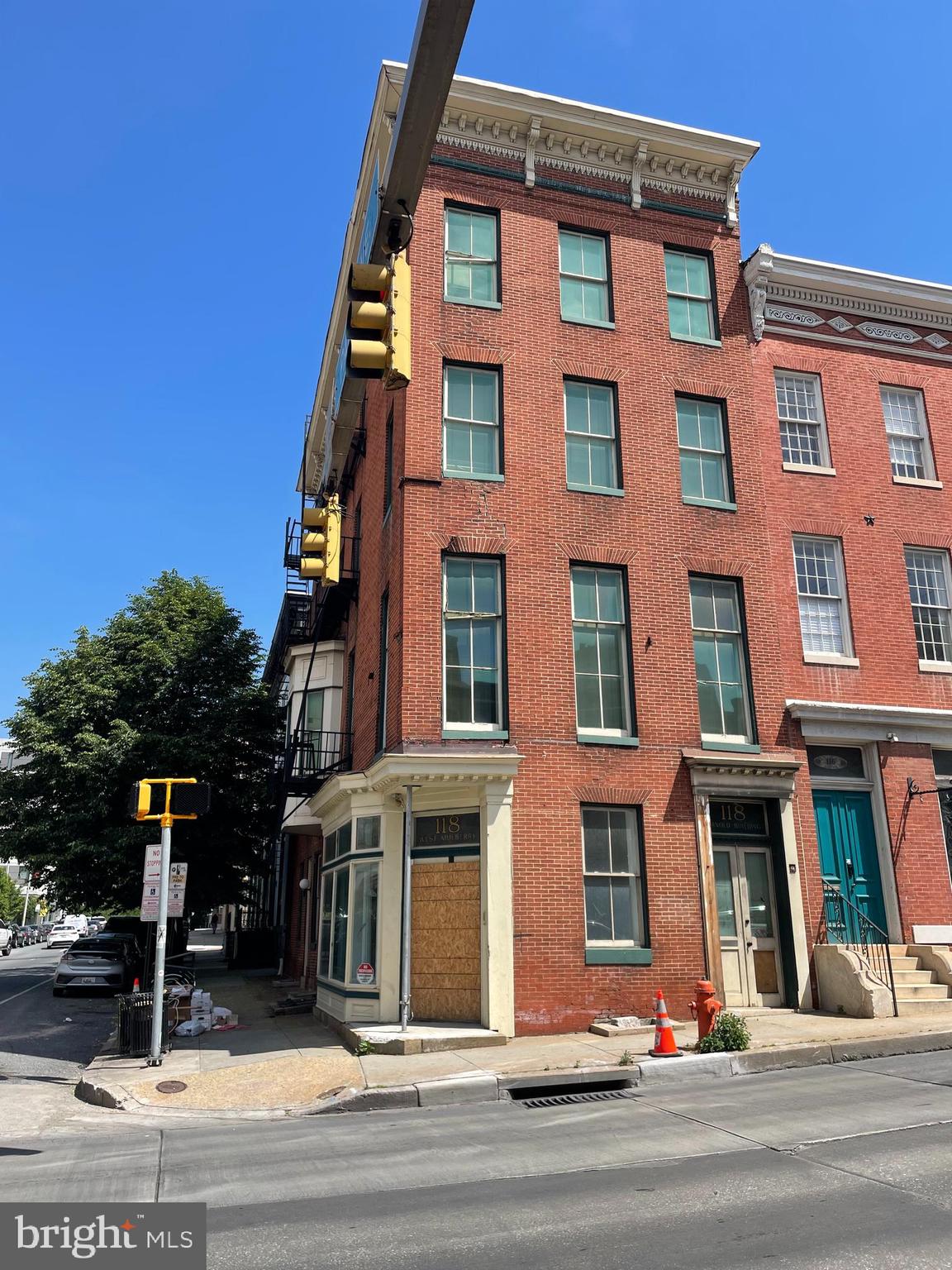 Four-story corner property in need of refurbishment located at the intersection of Mulberry Street and Park Avenue in Baltimore's downtown neighborhood. Sale is subject to receivership terms. Before closing, the City will need to see proper documentation of the Buyer's ability to rehabilitate. The property offers impressive square footage and allows versatile potential, having been used previously as both a law office and art studios.The C5-HT zoning allows for flexible division of the space, accommodating either mixed residential or commercial use. The interior is full of possibility, featuring south-facing rooms with tall ceilings and abundant natural light. Built-in bookcases, a remnant of the property's law office days, add a unique charm. Currently, the configuration is ideal for studios or offices with a street level gallery. Its prime location offers close proximity to the central Pratt Library, the Bromo Arts and Entertainment District, the Mt Vernon Marketplace, and Baltimore's Chinatown.
Under terms of receivership filing, prior to closing, the City would like to see a detailed rehabilitation plan from the proposed buyer. The plan should include a scope of work from a licensed Maryland contractor on letterhead with the MHIC number, and an itemized list of what the property needs to be brought up to a Use & Occupancy standard. The plan should also include a time estimate and a cost estimate. Based on the cost estimate, the City will need to see proof of financing. This can be a letter from a bank, a snapshot from an account, or something that shows they have the financial ability to complete the project as outlined.