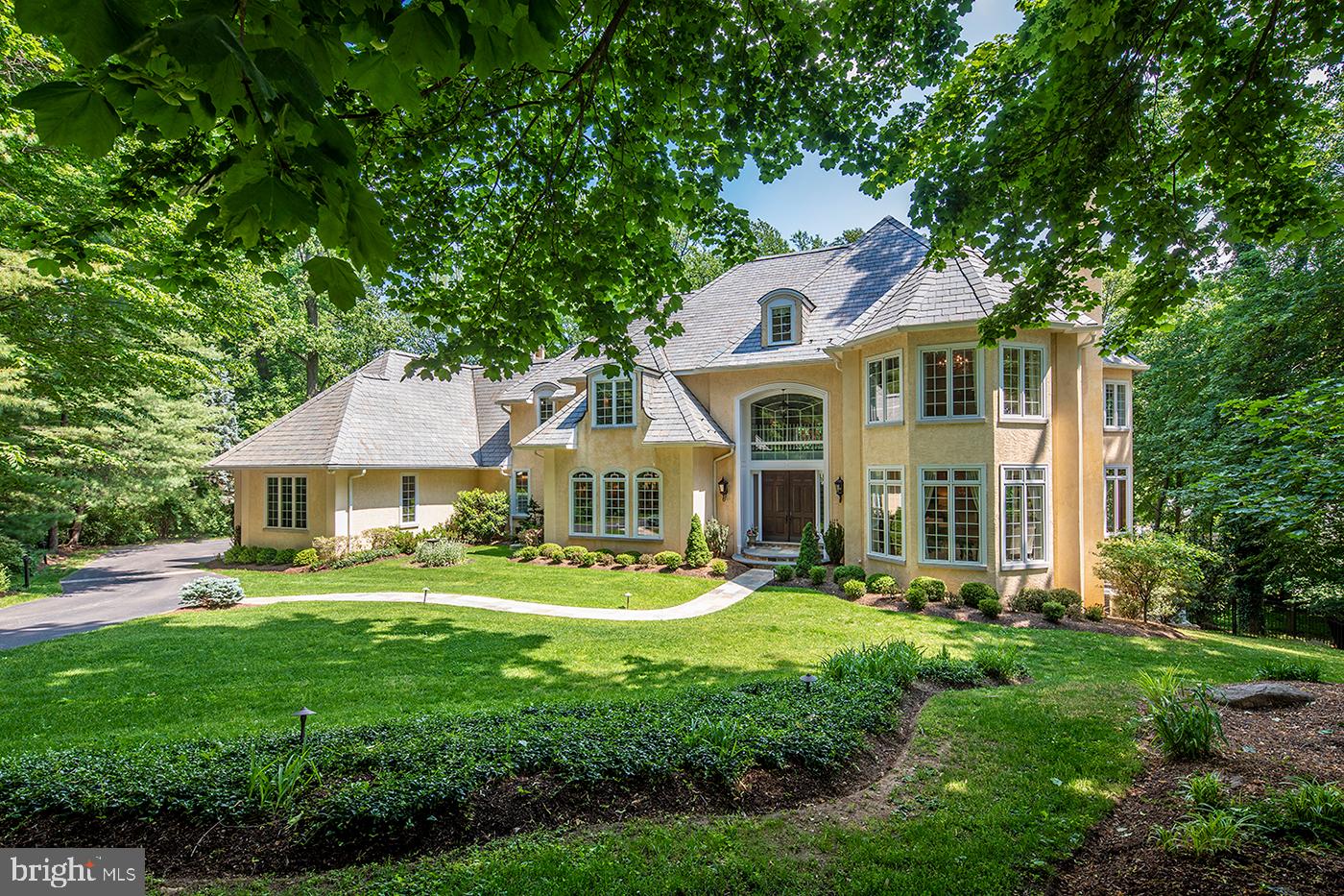 Unrivaled craftsmanship and meticulous attention to detail are on full display at this exquisite French Manor estate sited on over an acre in idyllic D’Orsay. An architectural gem in the heart of the award-winning Radnor Township, this impressive family home was thoughtfully custom built, boasting ultimate privacy, a premier lot location, soaring ceiling heights, and a timeless, high-end finish-out at the end of a quiet cul-de-sac development. Nearly every inch has been upgraded and impeccably maintained for modern-day, allowing for effortless luxury living indoors and out. Lushly landscaped and light-filled, it affords 7 bedrooms, 7 full and 3 half-bathrooms, a sparkling swimming pool and spa with tranquil fountains, fully equipped outdoor kitchen, and expansive deck with serene, heavily wooded views. Topping the allure are grand and intimate formal rooms built to entertain that were featured in Main Line Today magazine, and a fully finished walk-out basement. All of the major investment and remodeling has been done for you! This includes a recent chef’s kitchen with top-of-the-line appliances, ample countertops, 2 generous custom pantries and butler’s pantry, plus a tastefully renovated primary suite with a fireplace, spa bath, and custom walk-in closet. Other highlights are custom draperies and remote-controlled shades, beautifully refinished and newly installed hardwood and engineered hardwood floors, state-of-the-art Lutron lighting controls, whole house speakers, and so much more. There are original touches to admire too, from the stunning custom millwork to the 3 stately fireplaces, and handsome cherry-paneled study with floor-to-ceiling built-ins that’s ideal when working from home. For the consummate host, a grand marble entry and elegant formal dining room featuring hand-crafted plaster moldings and cabinetry set the tone. Even more fabulous features include a sweeping staircase, oversized windows streaming an abundance of natural light, richly appointed guest suites, each with private en-suite bath and walk in closet, a secondary family room and kitchenette, and secluded 3rd-floor level that’s great for an au-pair or in-law retreat. As the only house in the development with extra height in the poured foundation, the lower level walk-out basement is also a showstopper, offering high ceilings and a comfortable layout as the entertainment center of the house. This haven comes complete with a spacious gym, billiards and game room, an inviting home theatre. Tucked away on a quiet, tree-lined cul-de-sac, few offerings compare! A 3-car garage, easy walkable access to parks, train stations, top-rated schools and shops, and close proximity to the village and airport make this one a keeper. Don’t miss your chance to experience the beauty and lifestyle firsthand.