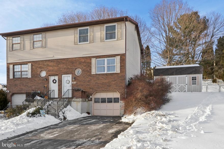 Beautiful 3-bedroom, 2-bath twin home in convenient Overlook Estates, Bethlehem Township. Built in 1987, 1,380 sq ft home plus partially finished basement and a fenced backyard. No HOA fees for true low-maintenance living. Step inside to a bright, open layout. Spacious living room with built-in shelving, large picture window, and Pergo flooring throughout the main level. Inviting kitchen and dining room features chair rail, crown molding, stainless steel appliances, pantry, and slider to the fenced backyard. Relax and entertain on the nice new paver patio perfect for cookouts and gatherings. Remodeled powder room completes the first floor. Upstairs: three generous bedrooms with ample closet space and updated full bathroom. Partially finished lower level offers extra living space (playroom, gym, or family room) with laundry room w/ washer/dryer hookup. Central air too! Recent 2024 upgrades include replacement windows and forced-air furnace. One-car garage with storage plus driveway with room for additional cars. Attic space and large shed for additional storage. Prime location near Birchwood Park, D&L Trail, St. Luke’s Anderson Campus, shopping, dining, and just 2–3 miles to Routes 33, 78 & 22. Quick commute to NJ (approx. 10 miles) and NYC and close to commuter express bus line. Schedule your private tour today!