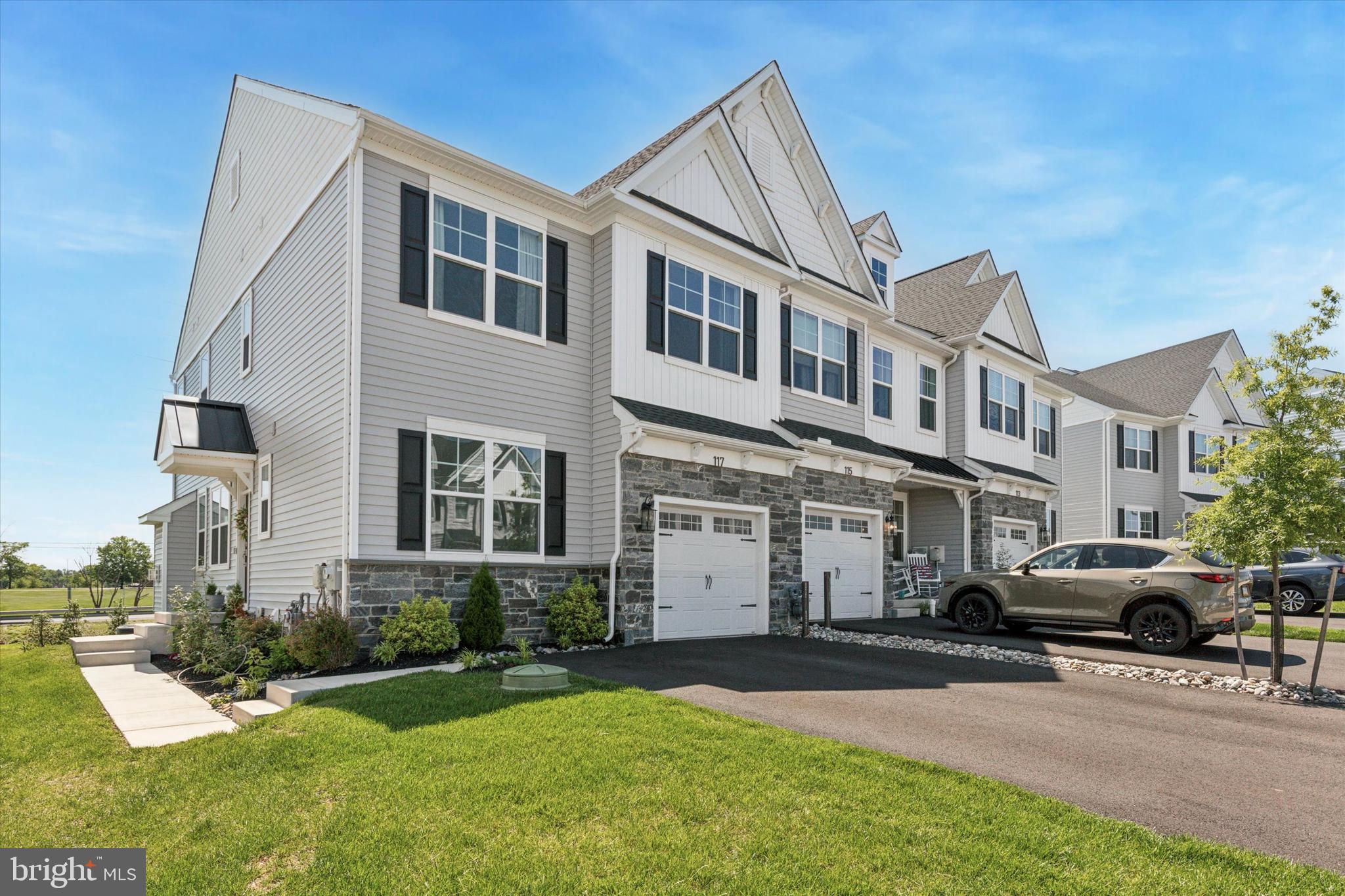 Welcome to 117 Charles Lane, Harleysville, where your search for the perfect home concludes. This exquisite end-unit townhome, located in the sought-after Highpointe at Salford, epitomizes elegant minimalism and modern living. Nearly new, this premium residence features 3 bedrooms and 2.5 bathrooms, designed to offer both beauty and functionality. Endless upgrades throughout. Enter through the inviting front porch into the main living level, where an open concept design welcomes you with 9' ceilings, beautiful hardwood flooring and abundant natural light. The expansive living room, accented with a cozy gas fireplace, flows into a spacious dining area. The gourmet kitchen stands out with its oversized island, ample cabinetry, pantry, stylish tile backsplash, quartz countertops, and premium stainless steel appliances. Sliding glass doors lead to a generous maintenance-free deck, perfect for peaceful mornings or relaxing evenings. A separate den/flex room and a powder room complete this level, adding to the home's functionality. Upstairs, the sophisticated primary suite awaits, featuring a vaulted ceiling, generous windows, and two walk-in closets. The luxurious primary bathroom offers an oversized shower with a glass enclosure, a double bowl vanity, and elegant tiled flooring. Two additional bedrooms, a stylish hall bathroom, a linen closet, and a laundry room provide flexibility for family, guests, or work-from-home needs. Nestled in the heart of Harleysville, close to shops, schools, parks and great restaurants. Also quick access to major routes including 63,113 and the PA Turnpike. Experience the perfect blend of luxury, location, and lifestyle by scheduling your private showing today!