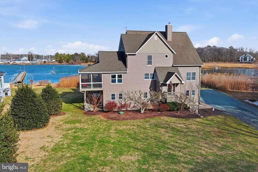 This spectacular waterfront retreat offers over 3,500 square feet of living space on 0.76 acres, ideally located within the town limits of Rock Hall. With an elevator, five bedrooms an office and four and a half baths, there is abundant space for family, guests, and effortless entertaining.
The ground level welcomes you with a spacious game room, sitting area, exercise space, and an oversized two-car garage. A split-level entry foyer leads to the main living area, where an open-concept layout seamlessly connects the living and dining rooms. The expansive kitchen with two sinks and wine fridge is designed for both function and gathering, featuring generous cabinetry and ample countertop space. Just off the kitchen, the family room with vaulted ceiling, opens to a screened porch—perfect for enjoying cool breezes and waterfront views. A deck spanning the width of the home provides additional outdoor living space  and includes an electric hoist for firewood or groceries. A living room with wood stove, office and full bath complete this level.
An elevator provides easy access to the upper floors. Level three showcases a spacious primary suite with stunning creek views and abundant wildlife, along with two additional bedrooms and a full bath. The fourth level offers two more bedrooms and another full bath, creating flexible accommodations for guests or multi-generational living. Every bedroom and living space in the home enjoys water views.
For car collectors and hobbyists, the property features a total of four garage spaces, offering exceptional storage for vehicles, boats, and recreational toys. The two car detached garage is heated. This is a rare opportunity to own a spacious waterfront home with panoramic views, versatile living areas, and in-town convenience.