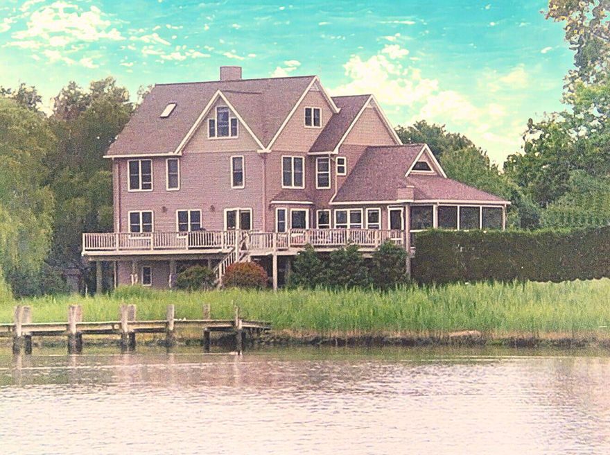 This spectacular waterfront retreat offers over 3,500 square feet of living space on 0.76 acres, ideally located within the town limits of Rock Hall. With an elevator, five bedrooms an office and four and a half baths, there is abundant space for family, guests, and effortless entertaining.
The ground level welcomes you with a spacious game room, sitting area, exercise space, and an oversized two-car garage. A split-level entry foyer leads to the main living area, where an open-concept layout seamlessly connects the living and dining rooms. The expansive kitchen with two sinks and wine fridge is designed for both function and gathering, featuring generous cabinetry and ample countertop space. Just off the kitchen, the family room with vaulted ceiling, opens to a screened porch—perfect for enjoying cool breezes and waterfront views. A deck spanning the width of the home provides additional outdoor living space  and includes an electric hoist for firewood or groceries. A living room with wood stove, office and full bath complete this level.
An elevator provides easy access to the upper floors. Level three showcases a spacious primary suite with stunning creek views and abundant wildlife, along with two additional bedrooms and a full bath. The fourth level offers two more bedrooms and another full bath, creating flexible accommodations for guests or multi-generational living. Every bedroom and living space in the home enjoys water views.
For car collectors and hobbyists, the property features a total of four garage spaces, offering exceptional storage for vehicles, boats, and recreational toys. The two car detached garage is heated. This is a rare opportunity to own a spacious waterfront home with panoramic views, versatile living areas, and in-town convenience.