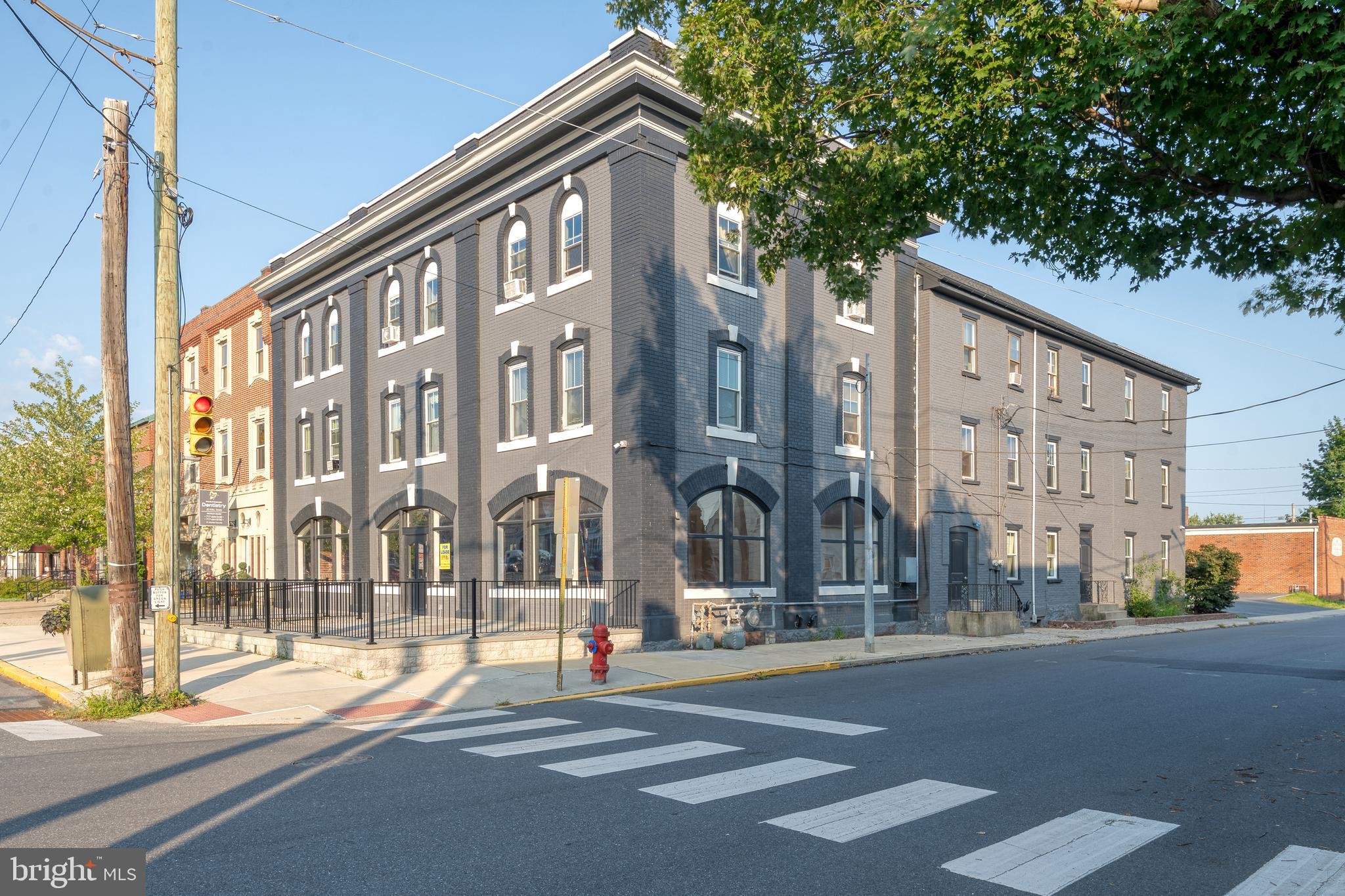 Amazing mixed-use investment opportunity in Manheim's Market Square with 11% cap rate! Formally known as the Washington House, this historic landmark has been restored. High-visibility corner lot with 8,000/day traffic count. This iconic brick building is comprised of a large 1st floor commercial space + fully-occupied 25-unit boarding house on the 2nd & 3rd floors. The first floor commercial space is currently being offered as-is for $2,500/month + NN or with 10 year commitment and an allowance of $65/sqft to built it out ($277,745) + NN, and is the perfect blank canvas for a restaurant/cafe, etc. 1st Floor could be divided into 2-4 spaces to maximize rent potential. Large arched windows and a new paver patio extends across the front of the building, ideal for outdoor seating & high visibility. The open space features the rustic charm of exposed beams and brick. Rear parking lot includes 12 spaces + free street parking all around! See MLS #: PALA2053148 for more lease details. The 25-unit boarding house is fully-occupied with a waiting list to get in. Tenants pay flat weekly rate between $160-$185 per week, owner pays all utilities. Most units have been updated and feature newer LVP flooring. Benefit from many new upgrades including all new metal, architectural shingle, and rubber roofs, fully painted exterior, new windows throughout, upgraded electrical, newer plumbing, newer HVAC (2 years old)! Other highlights include hardwired security system, 2 gas furnaces, new central A/C. In addition, there is a suite that will rent our for $270 per week with a full kitchen and a loft. Schedule your private showing before it's too late!