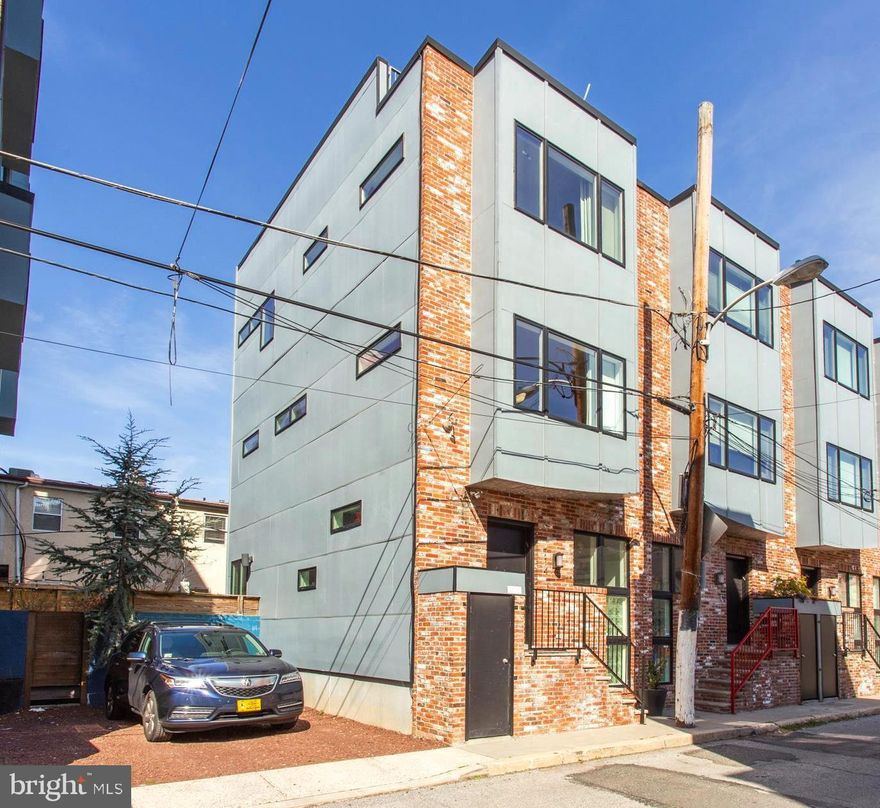 Highly sought after high-end sustainable living at its finest, in AWARD WINNING Bancroft Green Phase II (recipient of the Jerry Rouleau Award for Excellence in Home Design), featuring a creative approach to daylighting, incorporating light wells and clerestories to successfully bring light deep into the unit. This 3 story, 3 bedroom, 2.5 bath, home with patio and roof terrace is designed by Best of Philly: Green Architect (2009): Re: Vision Architecture. This unique end unit has 3 exposures for maximum natural light. A handsome contemporary beautiful reclaimed brick facade greets you out front, with secure street level storage for bikes and strollers. Inside you'll find an open layout eat-in kitchen, living room and dining room with extra high ceilings, 2-zone geothermal HVAC (BIG savings on utilities); increased insulation (LEED BD+C) and Pella Low-E windows, save money and help the environment. The modern kitchen boasts granite countertops, stainless steel appliances, luxurious glass tile backsplash, a bar counter, as well as a convenient half bath and door out to a private patio that includes an extra piece of land that was purchased to increase the size of the lovely urban garden with upgraded fieldstone, flower boxes and fish pond, perfect for BBQing and outdoor entertaining. The second floor features a large bedroom, spacious full tile bath with stall shower and dual vanity, walk-in closet, and laundry. On the third floor you'll find two bedrooms one with ceiling fan and a full modern bath. Door leading to rooftop deck with sunrise to sunset unobstructed views - ideal for relaxing and entertaining, with cable hookup! The finished lower level makes a great additional living space (den, office, family room, you name it) while also including, storage and mechanicals. This home is nestled on a lovely, VERY QUIET non-thru street, convenient to Rittenhouse, Sprouts Market, Revel Ride, & South street restaurant row. Possible parking right next door, upon approval by parking spot  owner. Check with OPA for remaining abatement.