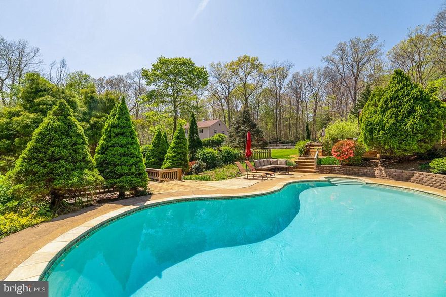 Rare opportunity to purchase this stunning 5-acre property with over 2900 finished sq ft in the highly sought after Lake Occoquan Shores community! Located on a private road close to Clifton and historic Old Town Manassas. 3 bedroom 2 bath home with attached oversized 2-car garage features a heated in ground pool plus additional detached structure with heated and cooled 2-car garage, workshop, and fully finished entertainment space/game room! House features a chef's dream kitchen with 6-burner gas range/grill with hood, double wall ovens, high-end Viking and Dacor appliances, 2 sinks, standalone ice maker, center island, tons of cabinet space, and built-in storage pantry. Living room has fireplace with Buck wood burning stove. Both bathrooms have heated floors. Upgraded trim and crown molding throughout. 24 windows and 8 skylights let in a ton of natural light. Whole-house generator just serviced and both propane tanks filled. 2 storage sheds. Fenced rear yard. Fully enclosed 900 square-foot garden with running water. Fully encapsulated crawlspace with perimeter drain system. Seller has design plans for addition to the house (see MLS docs). Detached structure completed in 2017 features a massive 1,000 square-foot 2-car garage with workshop and a 1,000 square-foot entertainment space above. Garage has 80 amp service with (5) 220v and (10) 110v electrical receptacles downstairs and (12) 110v receptacles upstairs, 3 work benches and a utility sink. 2 Wi-Fi controlled vehicle entry doors and 2 standard entry/exit doors. Entertainment space features a 6-person custom oak bar with built- in kegerator and tap, built-in icemaker, full-size refrigerator, pool table, poker table, shuffleboard table, and 70” TV. All furniture and games in the entertainment space convey! Has cable TV and Wi-Fi. Structure is built on a monolithic turndown concrete slab, 2x6 lumber, 30 year architectural roof, and R19 insulation. Fully heated/cooled by a 36,000 BTU Carrier mini-split system. 16 windows for a ton of natural lighting plus LED light fixtures throughout. This gorgeous 5-acre property is approximately 3 acres wooded, 2 acres cleared, has 5 apple trees, lots of bird houses and feeders, a hummingbird flock, front yard water fountain, and creek running through the backyard. Pool has a brand new pump and booster pump for cleaner. All pool and patio furniture conveys. Parking for approximately 20 vehicles. Neighborhood has new underground utility lines. Lake Occoquan right down the street and Bull Run Marina 3 minutes away. Only 4 miles away (at Liberia Ave) are a huge variety of stores like Harris Teeter, CVS, gas stations, Walmart, Aldi, Lidl, restaurants and much more. Go another 2 miles and enjoy quaint Historic Old Town Manassas with art galleries, theatre, farmer's market, non-chain stores, salons, amazing restaurants and other small businesses. Go 15-20 minutes the opposite way and enjoy Potomac Mills Mall and IKEA. 20-25 minutes to I-66 in Centreville and to I-95 in Woodbridge or simply utilize the convenient VRE commuter train from the Historic Old Town Manassas or Manassas Park stations mere minutes away.