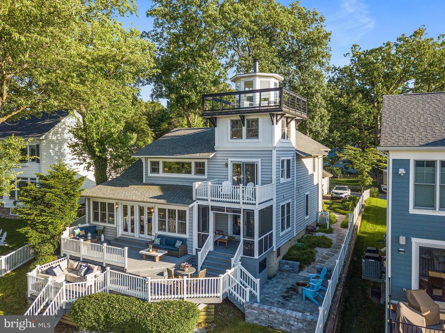 Welcome to 728 Oak Grove Circle! The ONLY home in Maryland with its very own square lighthouse! This waterfront beauty is located in the highly sought after Manhattan Beach community which is known for waterfront living. Let boating life begin with just over 60-feet of water frontage, with easy access to the private dock with 6-8 feet depth, including an 8,000 lb lift, on Cypress Creek, which feeds to the Magothy River. The front yard is beautifully landscaped, with a quaint front porch, and a lovely stone facade. As you enter this 4 bedroom 3.5 bath home you are immediately greeted by water views! The main level provides an open and airy feel as you entertain family and friends after a day out on the water. The large foyer leads into the renovated kitchen and spacious dining room. To the left is the living room with a wood-burning fireplace. Sit back and enjoy the fire while you take in the views of Cypress Creek. In addition, the main level offers a formal living room, 2nd bedroom suite, office, half bath, and a den. Upstairs you will find the primary bedroom suite with expansive water views and direct access to a rear balcony to enjoy your morning cup of coffee. The one of a kind lighthouse is accessed through the primary bath and as one of the highest points on the creek you can take in the 360 degree views from the top. Two large bedrooms and a full bath finish out the upper level. The lower level features a large family room with extra living space that can be used for a playroom, a home gym, or movie nights with friends. The showstopper of this home is the outdoor living! Your options are in abundance with a large 2-tier deck that includes two full seating areas, a dining area, and room for a grill. If you need a bit of shade, relax on the screened in porch. After a long day of boating, sit back on the paver patio while you watch your favorite movie on the outdoor TV. Whether you are having a large gathering or a quiet day at home this property offers the waterfront lifestyle you are looking for!  Don't miss out on this opportunity!