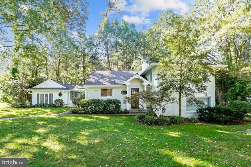Heavily wooded picturesque Wellington neighborhood is the stunning backdrop for this storybook home.  Charming details abound from the round windows, custom covered entries, brick construction and lush landscaping.  The 1/2 acre yard with inground sprinkler is perfect for tire swings,  football games, and casually catching up with the neighbors.  Step inside to the natural slate entry and you'll be struck by the arched living room opening and beautiful vistas of the backyard beyond. The large great room boasts hardwood flooring, a gas fireplace (could be converted back to wood burning), huge picture windows and a breathtaking kitchen with white cabinetry, stainless appliances, quartz countertops and a huge island with seating for 3 +.  The main level also has a glassed in breezeway that can be used as an office or buffet/serving area as you entertain on the flagstone patio out back.  Adjacent family room with glass doors is the perfect getaway for movie nights, or football games. A half bathroom is just off the room and perfectly situated for guests and everyday use.  Built in storage and closet space is everywhere providing room to hide the necessities on short notice. Upstairs you will find three spacious bedrooms with hardwood flooring and a recently renovated bathroom with tub/shower, beautiful vanity and contemporary tile finishes. Downstairs, you will find a fourth bedroom with a renovated en-suite bathroom (one of several spaces that could work well as an owner's suite).  Laundry and other storage spaces are also on this level. New roof /gutters (1 year old) and recent system replacements (furnace and AC 2 years old) allow for years of worry free ownership!  Wellington Heights is home to a variety of custom homes both large and small. The neighborhood is known for it's large lots, spacious homes, tree lined streets, and easy access to the GW Parkway, Old Town and beyond. Located in the sought after Waynewood school district, this home also offers easy access to a variety of private elementary and high schools. Major commuting routes including I-495, the GW parkway, Huntington Metro and local bus routes are just minutes away.   Don't miss your opportunity to come home for the holidays!