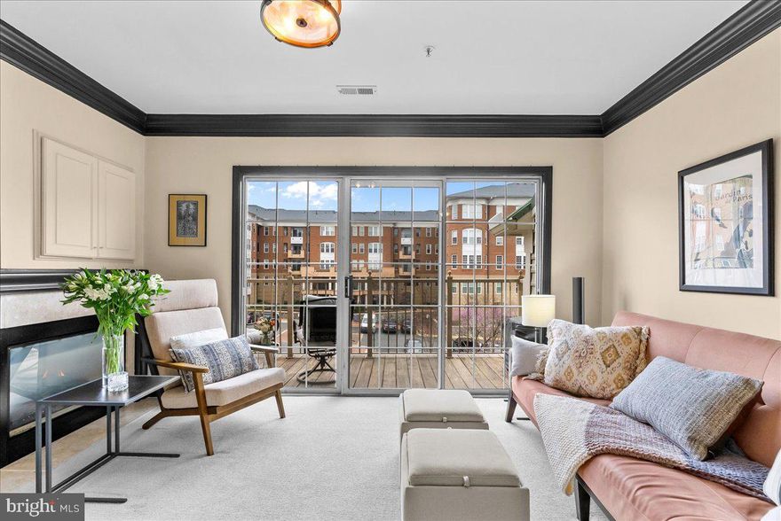 Location, location, location: Just one block from Main Street & University Drive, 10337 Sager Ave #304 puts you in a prime Fairfax City location with easy access to trails, restaurants, shopping, George Mason University, Library, City Hall, & beloved local shops. Perched on the penthouse level, this 2 bedroom, 2.5 bathroom condo enjoys open views & extra breathing room out the windows—an uncommon sense of space without feeling boxed in by nearby neighbors. Lovingly maintained, the home features updated double-hung vinyl windows with blinds (2020), renovated bathrooms, and a refreshed kitchen with granite countertops, stainless steel appliances, updated lighting, and newer microwave, dishwasher, & disposal. Each bedroom offers a walk-in closet, attached bath, crown molding, ceiling fans, and beautiful natural light. The primary en suite offers tasteful tile, soaking tub, walk in stand up shower, and a double vanity. Life here feels easy and inviting, with cozy evenings by the three-sided gas fireplace, quiet moments on the recently stained balcony, plus the convenience of a main-level half bath, smart thermostats, and two TVs with movable wall mounts that convey. Enjoy year round community events, festivals, live music & Forth of July festivities from your balcony! Say it again: location, location, location.