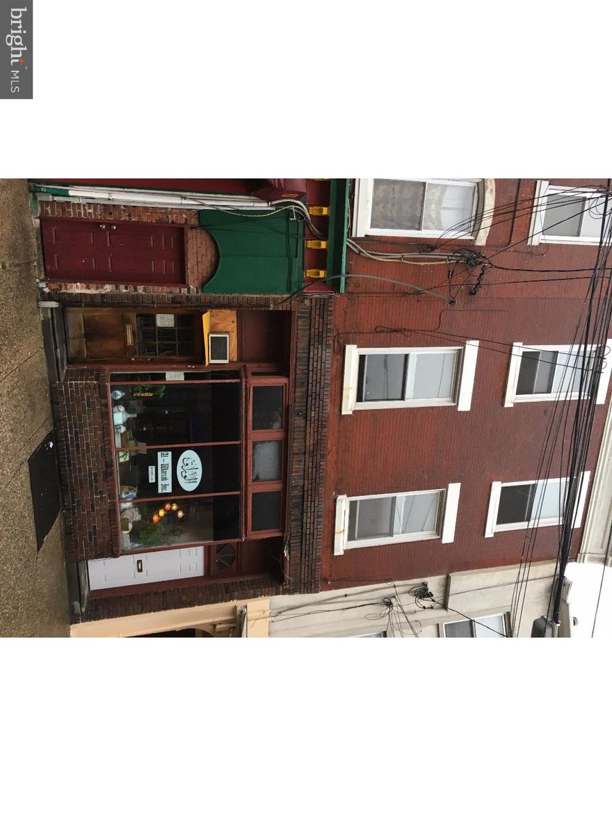 Fantastic opportunity! This is a commercial space plus 3 apartments just off Headhouse Square in Queen Village. The first floor commercial space is currently a bookstore, featuring a big wide open space with high ceiling, full bath, eat-in kitchen, two additional rooms and a door out to a side and rear yard. The second floor unit it a large 2 bedroom with wood flooring, 2 closets, eat-in kitchen and full bath. The third floor apartment is a 2 bedroom with wood floors, eat-in kitchen and full tile bath. The fourth floor apartment, accessible from the second floor rear stairway, is a bi-level 3 bedroom, 1 bath with eat-in kitchen and full bath. The common basement offers storage space, street access and mechanicals (gas hot water heater, 3 gas hot water tanks, 6 electric meters and 5 gas meters.) This building currently has two long term tenants and two vacant units. Located in Queen Village, convenient to parks, restaurants, shops, South St, Headhouse Square, Penns Landing, transportation and more.