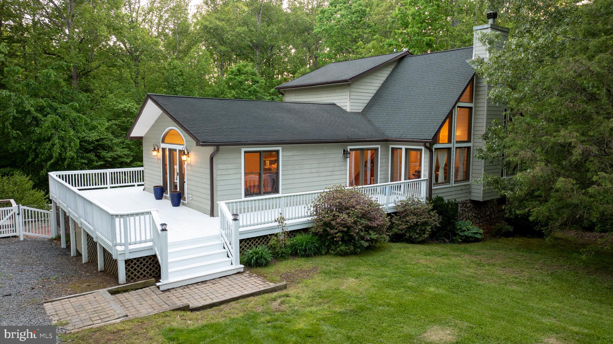 Ready to ditch the “maybe one day” dream and start living the lake life right now? This Lake Anna stunner is the perfect blend of vintage charm and modern flair—and she's got all the features that make buyers fall in love fast.
Tucked away on a peaceful, private 1-acre lot, this beauty gives you the quiet escape you crave—but still keeps you minutes from all the local hotspots: The Boardwalk, breweries, waterfront eats, and Lake Anna State Park (aka your new favorite place to hike off those wine tastings).
No more dragging your cooler across town to launch your boat. Your very own assigned slip (#43) is just down the street—because spontaneous sunset cruises and lazy lake days should be easy.
The resurfaced in-ground pool is calling your name. Host that epic summer bash or float solo under the stars with a cocktail in hand. Either way, the backyard is ready to be your summer headquarters.
Step inside and you’ll feel it—that warm, welcoming energy. Light-filled rooms, cozy fireplace, rich finishes, and a kitchen built for gathering (and charcuterie boards). Stainless appliances? Of course. Counter space? Plenty. Room to host? You bet.
Two balconies and a big ol' rear deck make your outdoor living dreams real. Morning coffee in peace. Dinner al fresco. Nature soundtrack on repeat.
With four bedrooms and three full baths, there’s room for the whole crew. The primary suite is a full-on retreat with soaking tub views and spa-like vibes. Downstairs? A finished walk-out basement perfect for guests, game nights, or turning into your ultimate chill zone or remote office escape.
We’re talkin’ newer HVAC, resurfaced pool, fresh decking—the kind of updates that mean more relaxing, less repairing.
Whether you’re hunting for that dream full-time haven, a high-potential Airbnb investment, or just a killer weekend escape, this place delivers. It’s got the lake access, the privacy, the updates, and the lifestyle that makes Lake Anna so dang irresistible.