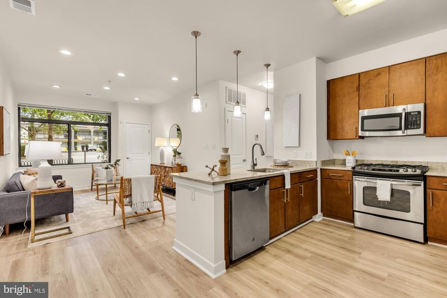 Living large in Downtown Silver Spring, welcome to unit 104 in The Orion Condominiums! This 2br/2ba  contemporary unit features just added wide plank rigid core birch LVP floors, a gourmet chef’s kitchen with custom cabinets, granite counters, gas range + high end stainless appliances, upgraded recessed lighting, and beautiful large spa like baths! The primary suite features a custom walk in closet and the whole unit benefits from loads of light from the multitude of windows. Other highlights include an in unit washer/dryer, additional closet and storage space, a just added Rheem tankless water heater, and high efficiency central heating and cooling. This unit is truly pristine!!<br>
A boutique contemporary  elevator building, The Orion boasts amenities like a state of the art gym, a residents sky lounge and party room, and is just steps to Red Line Metro as well as such notable attractions as The Flimore Silver Spring, AFI Silver Theatre, Quarry House Tavern, Whole Foods, Parkway Deli, & more!! Garage Parking is available directly next door for $132/mo (a secondary garage with EV charges just one block away and available for your use under the same parking permit!!) and there are also plentiful zoned street opportunities.  But with a walk score of 92 and a public transit score of 96 you don’t need a car to live and love life here. Pets are also welcomed. Come see this exceptional  condominium, in the heart of all that Silver Spring has to offer, for yourself today!!