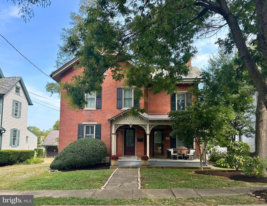 Welcome to one of Cottage Street’s most admired homes—an 1895 brick Victorian that has been transformed into a stunning modern residence through a top-to-bottom renovation in 2017. Every detail was thoughtfully designed to preserve historic character while adding today’s most sought-after comforts. Step through the leaded glass entry and discover the spacious combined living and dining room, where original hardwood floors, tall windows, colorful stained glass, custom plantation shutters, and exposed brick create a warm, light-filled gathering space. Perfect for entertaining or everyday living, this room flows seamlessly into the rest of the home. A brick fireplace anchors the family room, offering a cozy retreat or flexible home office with its own private porch access. The chef’s kitchen is a showstopper—custom cabinetry, granite island, Carrera tile backsplash, induction cooktop, sleek built-in microwave drawer, and a farmhouse sink blend seamlessly with the exposed brick wall and vaulted ceiling. A stylish mudroom, powder room with antique farmhouse sink, and laundry room complete the main level. Upstairs, the primary suite offers a spa-like bath with a barn door entrance, a frameless shower, double vessel sinks, plus a walk-in closet with custom storage. Two additional bedrooms and a designer hall bath complete the second floor. The third floor provides two more versatile rooms for bedrooms, studio, or fitness, along with a separate storage room. Outside, relax on the covered front porch, or enjoy entertaining on the cedar deck overlooking the deep backyard. A two-car carport with storage blends practicality with charm. With a new synthetic slate roof, copper gutters, efficient two-zone HVAC, and Anderson windows, this home is as functional as it is beautiful. All within walking distance to parks, shops, dining, and the County Theatre—plus Central Bucks School District. A rare opportunity to own a historic Borough home that feels brand new - make your appointment today!