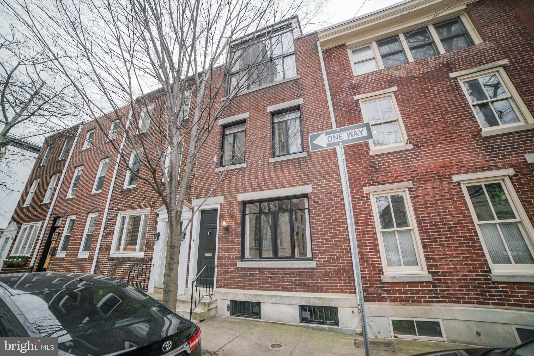 This lovely  town house is hidden away on a quiet street in Logan Square.  Enter into the Living Room with oak floors , working fireplace with marble mantle and a wall of built-ins. Galley Kitchen with separate exit to the yard. Rear Dining room with oak floors, built-ins and  a wall of glass overlooking a lovely garden with brick patio and plantings. 2nd floor: rear Bedroom with oak floors, Hall tiled Bath with linen closet, Front  Bedroom with carpet. 3rd floor: is the great room, with a wall of windows facing north. This was renovated for the Philadelphia artist, Franklin C. Watkins who lived in the property in the 1950s. The room has random width pine floors, built-ins and a Cathedral ceiling.  There is a full bath with shower. The Basement has the washer/dryer, gas hot water heater and gas forced air heater.  The property has central air.