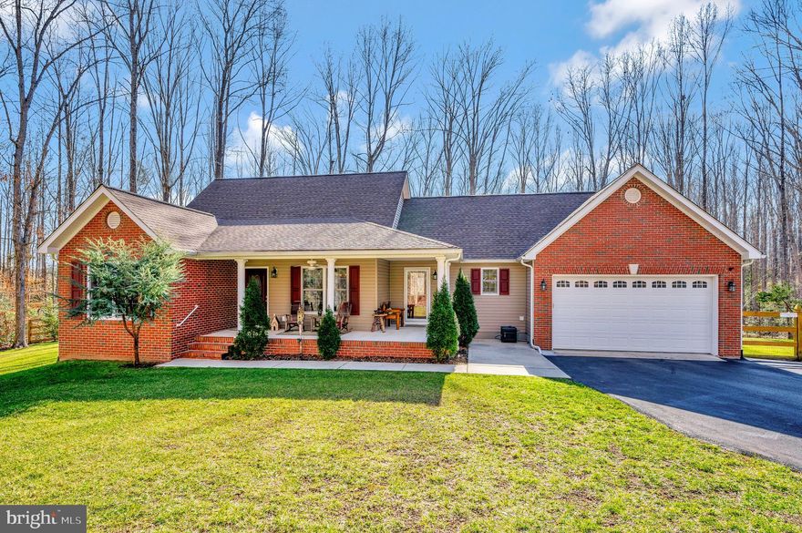 One owner rambler with full walkout basement on 5 secluded acres in private gated setting.  This home has 4 bedrooms/3 full baths and a 5th NTC bedroom.  Open floorplan with cathedral knotty pine ceiling and floor to ceiling stone gas fireplace in great room.   Oak hardwood floors in main living areas, kitchen and halls.  Kitchen has granite countertops and stainless steel appliances.  Separate dining room, breakfast area and pantry.   Expansive primary bedroom with 2 closets (1 walk-in), door to rear deck and en suite bath.  Primary bath has large tiled shower with glass shower door;  2 shower heads;  bench;  jetted tub and double sinks with granite countertops.  Laundry room with laundry tub and cabinets for storage.  Split bedroom design with 2 additional main floor bedrooms separated by hall bath.  Basement has 1169 finished square feet and features living area; full bath; 1 bedroom (currently used as home gym); additional NTC bedroom and plentiful unfinished space for storage.  Large front porch and 10'x42' covered deck with ceiling fans for outdoor enjoyment.  Large stone patio with firepit and covered wood rack.  Attached 2 car garage and an additional 16x26 detached garage with 9 foot door and built in workbench.  Paved driveway has area next to detached garage for additional parking.   Large fenced rear yard backs to trees with walking trail around property.  Property extends beyond fence to open field in back.   Home wired for 30 amp portable generator with easy access on side of attached garage.  Propane tank for fireplace is owned not leased.  Gutter guards on main home.   Make your appointment today!