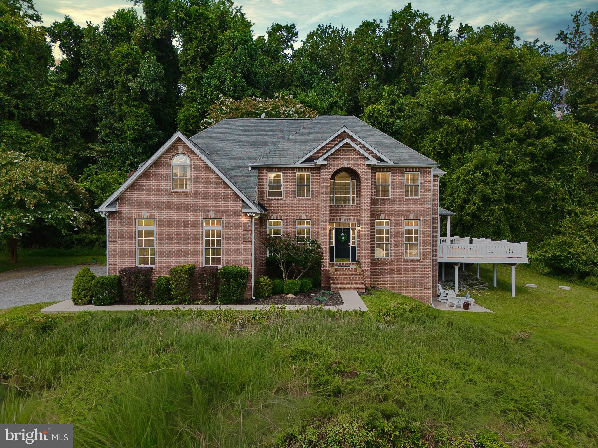 Powers Avenue is a stunning classic colonial set on a scenic 4.36-acre lot that offers both privacy and grandeur. This 5,300 square foot home is the epitome of traditional elegance, featuring a spacious five-bedroom, three-and-a-half bathroom layout with 10-foot ceilings that create a sense of openness and luxury. The Anderson windows and hardwood floors, along with the freshly painted neutral tones throughout, ensure a modern, inviting aesthetic. The home’s interior is as functional as it is beautiful. The large open chef's kitchen, complete with an island and seating area, is perfect for both casual meals and entertaining, while the formal living and dining areas provide space for more traditional gatherings. Entering the home, you’re greeted by a two-story foyer with a grand staircase that sets the tone for the rest of the house. The living room, with its gas fireplace and soaring two-story ceilings, is a centerpiece of comfort and style. The main level also includes a versatile office or bedroom, a half bath, and a mudroom. The fully finished walk-out basement adds significant living space, featuring a bedroom, full bath, recreation room, and additional living area, making it ideal for guests and family. The master bedroom upstairs is a private retreat, boasting a gas fireplace, tray ceilings, walk-in closets and a spa-like bathroom with a stand-up shower, garden tub, and dual vanities. Two additional bedrooms are located upstairs (with newly replaced carpet in 2024), one of which is a double room that could easily be converted into two separate bedrooms. The loft area, overlooking the living room, boasts beautiful views, adding to the home’s open feel. The loft can easily be finished as a 4th bedroom upstairs. Second-floor laundry is a convenient luxury! Outdoor living is equally impressive, with a pergola and 1,250-square-foot composite deck that wraps around the back of the home, offering breathtaking morning and evening views of the surrounding landscape. The front of the home overlooks lush greenery, including a charming spring house, adding to the scenic ambiance of the property. The three-car garage (new door 2023), equipped with an electric car charger and a generator plug access via the electric panel, caters to the needs of today’s homeowners. This residence is not just a home; it's a lifestyle - one that combines traditional charm with modern conveniences, all set in a picturesque, secluded setting with easy access to I-83, I-695, NCR trail and Hunt Valley Town Center. Brand New Kitchen Upgrades include Countertops, Backsplash, Sink, and Lighting. 2024 - New Carpet, New Garage Doors and New 80 Gallon Hot Water Heater.