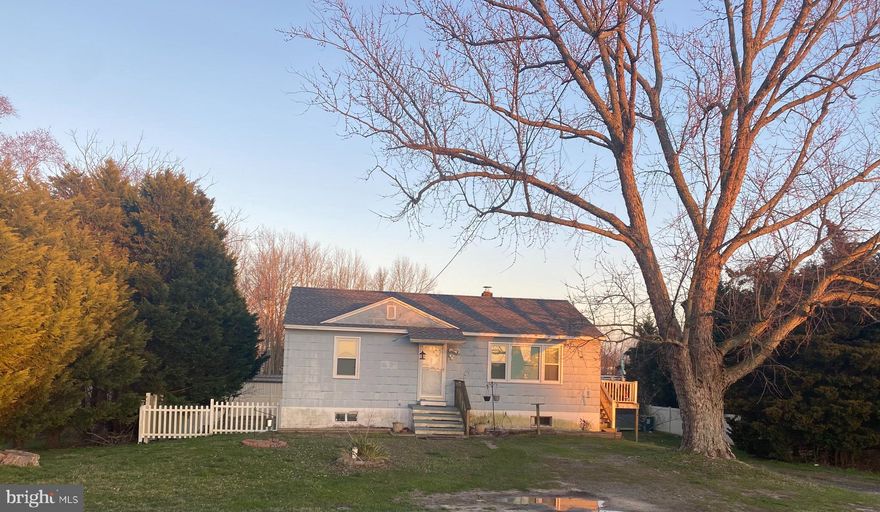 RESIDENTIAL/COMMERCIAL .... Zoned C-2 located just outside of Berlin town limits on Main Street....NO BERLIN TOWN TAXES, NO WATER AND SEWER FEES!!!  This home has 2 bedrooms and 1 full bath, living room, and eat in kitchen on the main level with washer and dryer hook-up and a walk up attic. The lower level has 1/2 bath roughed in and full size washer and dryer with sliding glass door walk out to the fenced in private back yard.  Well was replaced in 1994. New Windows in 2017 with Lifetime Warranty. New Roof in 2020. Roadbed has been annexed into the Town of Berlin with public water & sewer hook up available. This property has so much potential... remain as a single family home with room to add on or possibly covert to rental/ investment property, professional office, barber/salon, and/or retail shop with great exposure on the main road in and out of the Coolest Small Town in America. Being Sold "AS IS".