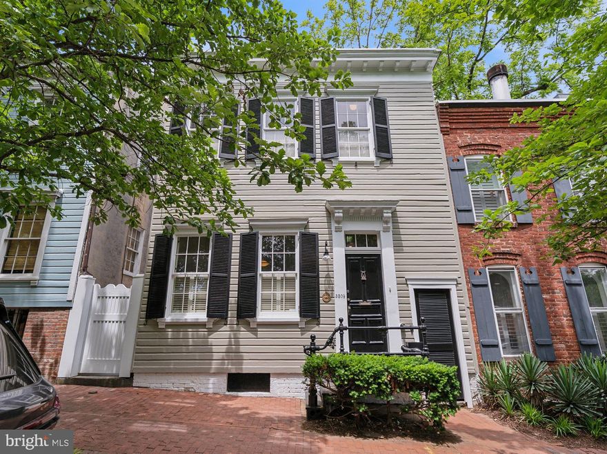 Nestled in one of Washington’s most coveted neighborhoods, this impeccably maintained three-bedroom, two-and-a-half-bath residence blends timeless Georgetown charm with thoughtfully curated modern updates. Encompassing over 2,300 square feet, the home offers classic architectural detail, elegant proportions, and a private garden oasis that redefines urban living.

The main level features a living room with hardwood floors, soaring ceilings, and a stately fireplace that creates a warm and inviting atmosphere. An expansive den with custom built-in shelving opens to a dining area and an updated kitchen that flows effortlessly into a sunlit family room addition. From the family room, direct access to a deep, secluded garden creates the perfect setting for outdoor dining, entertaining guests, or cultivating your favorite plants and flowers. A tastefully updated powder room completes the main level, blending functionality with period-appropriate charm.

The upper level features a thoughtful layout, highlighted by a spacious primary suite with custom closets, a charming window seat with built-in storage, and lovely views of the yard. The updated en-suite bathroom features refined finishes and a large skylight that fills the space with natural light. Two additional bedrooms, one perfectly suited for a home office, offer flexibility, natural light, and comfort. A second full bathroom and large walk-in closet complete this level.

The lower level has been freshly painted and provides ample storage space.

This exceptional Georgetown home features elegant interiors and is perfectly situated within walking distance of the neighborhood’s premier shops, restaurants, and parks.