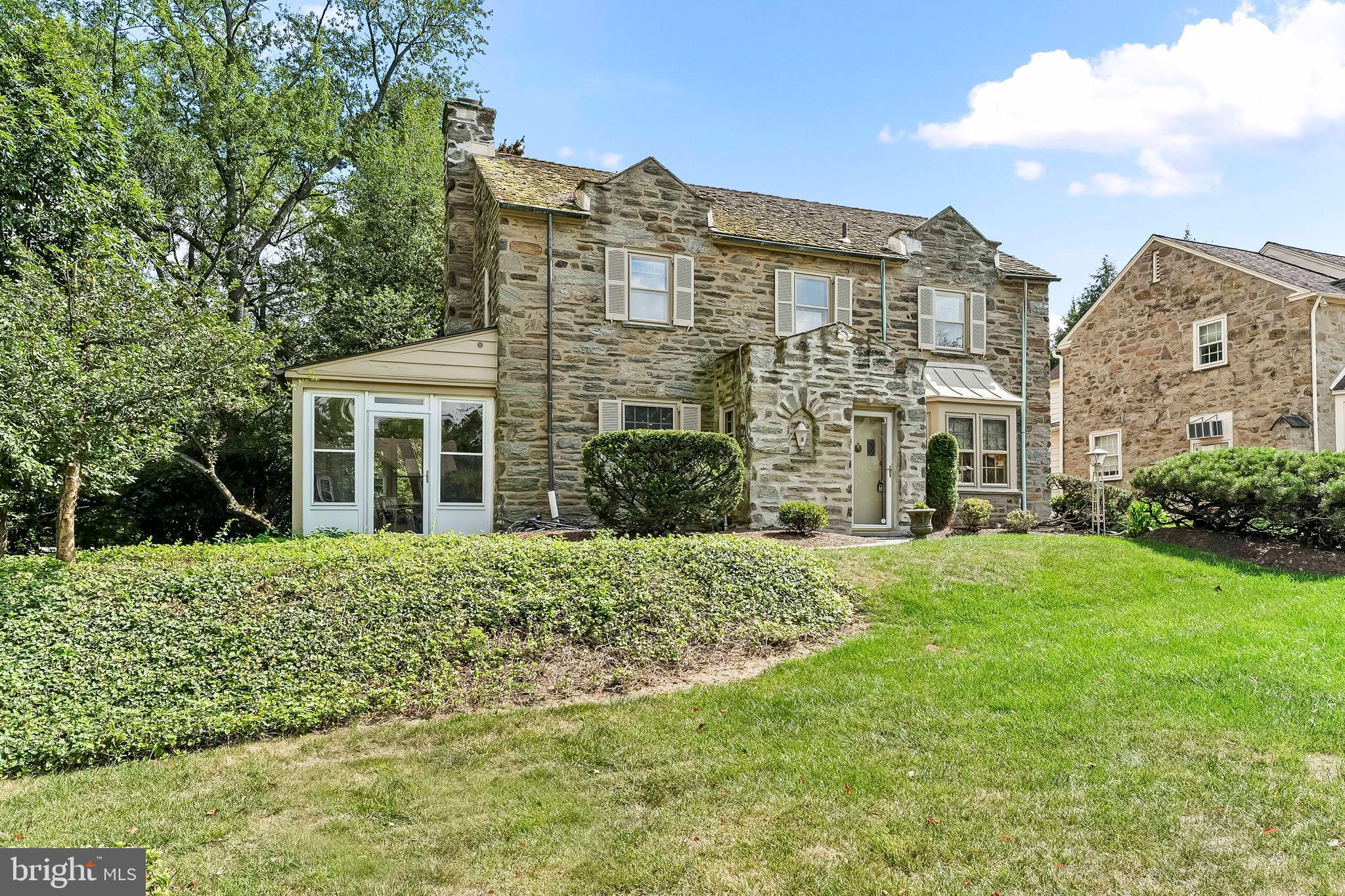 Welcome to 632 Foxcroft Road, a classic stone center hall Colonial in the heart of Elkins Park. Perfectly situated on a quiet, tree-lined corner lot, this beautifully maintained home offers a rare combination of charm, space, and privacy in one of the area's most desirable neighborhoods.
Step through the front door into a tiled foyer, with a split staircase directly ahead. To the left, you'll find a spacious living room centered around a wood-burning fireplace, leading seamlessly into a stunning, all-glass enclosed porch. This space is perfect for warmer months—ideal as a peaceful spring reading nook, a summer home office, or a creative escape when the weather’s right.
To the right of the foyer, the dining room makes a statement. Oversized and ideal for entertaining, it features unique stained glass doors that can be closed for privacy or left open to enhance the home's natural flow. There's also a powder room tucked conveniently off the front hall.
The large den at the back of the home is filled with natural light from a wide bay window that overlooks the beautifully landscaped backyard and sleek slate patio. Built-in wood cabinetry gives the room a warm, library-like feel.
The kitchen is outfitted with stainless steel appliances, upgraded granite countertops, and a functional eat-in layout. Just off the kitchen is a charming breezeway that serves as a perfect drop zone—ideal for groceries, gym bags, or everyday essentials when entering from the driveway. From here, you can also access the basement, which offers a large partially finished space complete with a bar area, a large hidden wine rack, a powder room, and a utility room.
Upstairs, there are four generously sized bedrooms and two full bathrooms. The primary suite includes an ensuite bath, and the upstairs laundry room adds extra convenience. Each bedroom features impressive closet and storage space, with hardwood floors hidden beneath the carpeting.
Additional highlights include a cedar shake roof, gorgeous stone exterior, a backyard shed for added storage, and thoughtful touches at every turn. Storage is a standout feature of this home, and you’ll be hard-pressed to find another with this much built-in functionality.
632 Foxcroft Road is nestled in a walkable, sidewalk-lined neighborhood close to local markets, top-rated restaurants, multiple train stations, and major highways. It’s been lovingly cared for over the years and is ready for its next chapter.
This is a must-see property that combines timeless architecture with practical upgrades in a setting that’s hard to beat.