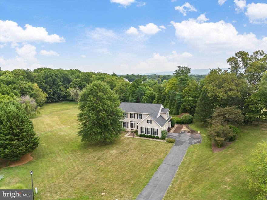 Step into luxury living at its finest with this exquisite colonial home nestled in Breckenridge North Community! Tucked away in a private cul-de-sac on 2.42 acres and surrounded by serene wooded views, this home offers a perfect blend of tranquility and elegance.

As you enter, you're greeted by a grand double staircase that sets the tone for the spacious open floor plan spread across all three levels. The gourmet kitchen is a chef's delight, featuring granite countertops, a convenient island, stainless steel appliances, and a butler's pantry for added convenience.

The kitchen seamlessly flows into the oversized morning room, perfect for enjoying your morning coffee while soaking in the picturesque views of your private backyard and custom stone patio with a firepit, creating the ideal outdoor oasis.

The family room provides ample space for gatherings and entertaining, while the formal dining and living room, elegantly combined and offset from the kitchen, offer a sophisticated ambiance for hosting guests.

Upstairs, retreat to the luxurious master suite complete with an additional sitting room, a large walk-in closet with a customized organizer, and a spa-like master bath featuring dual vanities, a soaking tub, and a ceramic shower. Three additional bedrooms and another full bath provide comfort and convenience for the whole family.

The fully finished basement offers additional living space with a full bathroom and walkout sliding doors leading to yet another brick patio, perfect for outdoor enjoyment. Ample storage space ensures all your belongings have a place.

Don't miss the chance to experience everything this remarkable home has to offer!