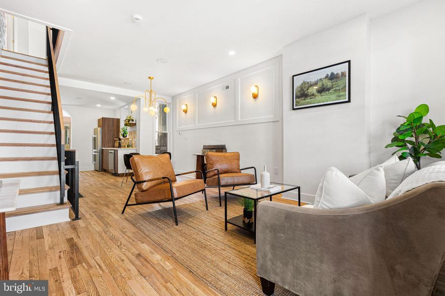 Brewerytown’s New Gem! Welcome home to a modern, mixed renovation featuring bright yet warm tones. This home has been fully restored from top to bottom, boasting brand-new hardwood floors throughout. Elongated windows allow natural light to flow in, beautifully highlighting the exposed brick. The chef’s kitchen is equipped with stainless steel appliances, including a sleek range that offers a timeless look, complemented by a gold pot filler for added convenience. Just off the kitchen, you’ll find a wet bar and a powder room. Step outside to a private backyard, perfect for entertaining or relaxing. The finished, cozy basement offers endless possibilities—whether you envision an office space, a game area, or a movie/sports lounge. As a bonus, it includes a full bathroom and a laundry area. Heading upstairs, you’re greeted by a custom staircase with elegant iron railings. The three bedrooms are generously sized, with the primary bedroom featuring a spacious closet. Ample storage is available in all bedrooms. Every detail of this renovation was curated to provide a sense of calmness paired with modern charm. Gold hardware flows seamlessly throughout the home and is designed for easy maintenance. Prime Brewerytown Location! This home is conveniently located near Center City and Fairmount Park. Just a ten-minute walk to Brewerytown Garden and Athletic Square Park, and a ten-minute walk to Girard Ave, where you’ll find local restaurants, bars, shops, and markets. Brewerytown offers plenty to explore, including landmarks like the Philadelphia Museum of Art (a 25-minute walk or a 7-minute drive), the Philadelphia Zoo, and Kelly Drive. Plus, there’s easy access to Girard College, public transit, and I-76. This listing won’t last long—schedule your showing today!