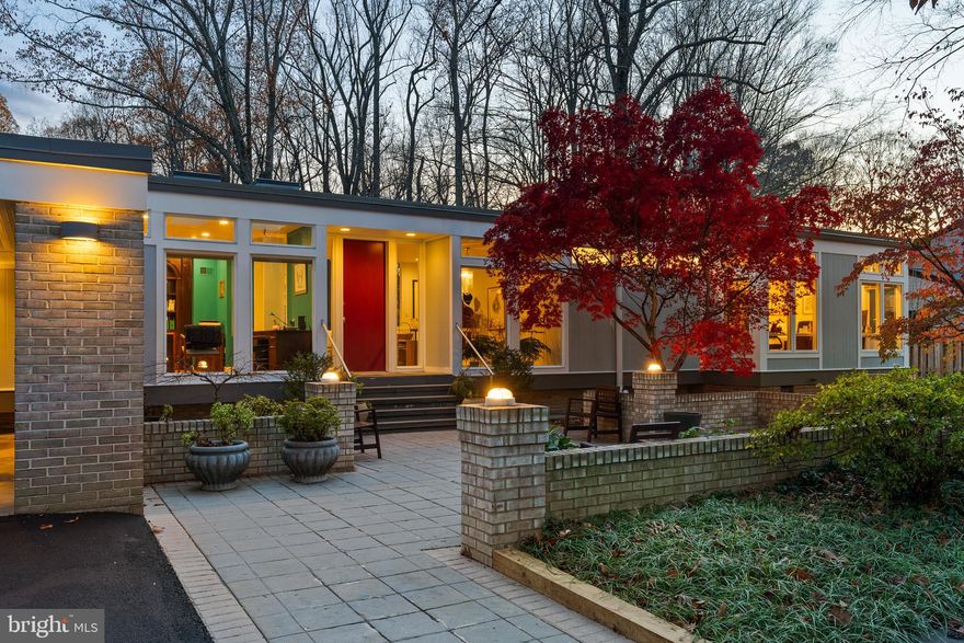 Welcome to 6904 Carmichael Ave, a stunning contemporary residence located in the prestigious Bannockburn Estates. Designed by modernist architect Donald Sickler with influences from minimalist pioneer Ludwig Mies van der Rohe, this 5-bedroom, 3.5-bath home is a testament to modern design, blending clean lines with timeless appeal and opportunities for indoor-outdoor living with complete ease and elegance.

Set on a nearly ½-acre private lot with built in swimming pool and backing to protected conservation land, this one of a kind home features 5 bedrooms, 3.5 baths plus 2 offices over 2 expansive levels.  With 11 foot ceilings and 100+ windows throughout, the interior is bathed in natural light.  The rear of the home is a stunning landscape of glass, seamlessly connecting the interior to the serene outdoors, offering a wide vista of the very best seasonal views of flora and fauna. Most all windows have been replaced, ensuring beauty and energy efficiency for years to come. 

Inside, a brand-new (2024) Jack Rosen custom kitchen takes center stage with high end appliances, including a Thermador "Freedom" Induction Cooktop with Best Cattura Downdraft, a Dacor 42" Refrigerator/Freezer, 2 Bosch dishwashers and a Miele Combi-Steam oven and a Miele Microwave/Speed oven.  The eat-in kitchen is surrounded by clerestory windows and opens to a renovated deck that allows another option for outdoor vistas not to be missed.  

The main level also features the primary suite with en suite bath with shower and tub and dual vanities.   Across the hall, you'll find a large office that could also be used as a bedroom.  The lower level features 4 large bedrooms, 2 full baths, a recreation room and library along with a laundry room and workshop providing versatile living spaces that cater to every lifestyle. The two-car carport provides ample built-in storage and convenience, while the lush grounds offer multiple spaces for outdoor relaxation or gatherings.

Situated in the sought-after Bannockburn Estates community, this home provides easy access to top-rated schools, parks, major commuter routes, and vibrant Bethesda.