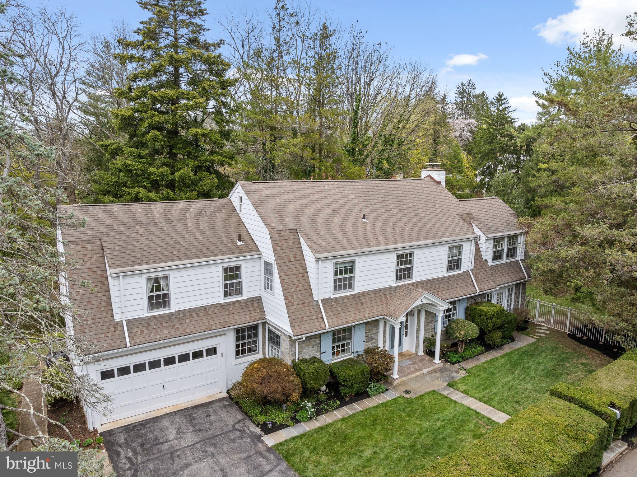 Tucked away on a storybook street in the heart of Saint Davids, 3 Canterbury Lane is a timeless 1928 Colonial that radiates charm, privacy, and classic elegance from the moment it comes into view. Nestled behind mature hedges on one of Radnor Township’s most picturesque and sought-after lanes, this treasured Five-Bedroom, Three-and-a-Half-Bath residence has been lovingly maintained by the same owner for over fifty years and is now ready to welcome its next chapter. A stone walkway leads you to a screened front door that opens into a gracious front-to-back Foyer, where warmth and character instantly unfold. To the left, the formal Living Room spans the full width of the home, anchored by a handsome fireplace and framed by French doors on either side that lead into a spectacular four-season Sunroom. Bathed in natural light and wrapped in original stone walls, this enchanting space offers gleaming hardwood floors, charming built-in touches, and panoramic views of the property’s lush landscaping, manicured lawn, and serene pool setting—an oasis that can be enjoyed year-round and is destined to become the heart of many cherished memories. On the opposite side of the Foyer, the formal Dining Room evokes timeless sophistication with deep-set window sills, a classic built-in corner cabinet, and a swinging door that leads directly into the updated Kitchen. Here, modern convenience meets enduring style with granite countertops, a built-in cooktop, wall ovens, and a full wall of cabinetry to meet every pantry need. A delightful Breakfast Area sits beside a charming bay window, while a sliding glass door opens to a spectacular flagstone Patio framed by stone knee walls and extending the length of the home—creating a perfect flow for entertaining and everyday living. Just beyond the patio, a gate leads to the private Pool area, seamlessly connecting indoor comfort to outdoor leisure. The Kitchen also features a functional built-in desk area and a secondary staircase leading to the upper floors. A sweetly tucked-away Powder Room beneath the main staircase adds convenience and charm to the First Floor. As you ascend to the second floor, you’re greeted on the landing by one of the home’s most captivating architectural details—an arched window with a custom window seat, offering a peaceful moment of reflection and a beautiful tribute to the home’s historic roots. The Primary Suite is generously proportioned and includes a sunlit four-season Porch with built-in bookcases, perfect as a private office, meditation space, or reading retreat. The Ensuite Bath features a tub-shower combination and a timeless pedestal sink. Two additional Bedrooms on this level boast hardwood floors and built-in bookcases and are serviced by a beautifully updated Hall Bath with a luxurious soaking tub and a towel warmer for added comfort. The back staircase leads to a private second-floor wing, where Two more Bedrooms and a Full Bath create an ideal guest, in-law, or au-pair suite. The Unfinished Basement runs the full length of the home and offers endless potential for added living space—imagine a home gym, media lounge, playroom, or wine cellar—while still maintaining abundant storage. With its enduring architecture, magical setting, and rich history, this home is a true jewel in one of Radnor Township’s most beloved neighborhoods and within walking distance to downtown Wayne. 3 Canterbury Lane is more than just a house—it’s a legacy property where past and future blend effortlessly, inviting its next owners to embrace a lifestyle of comfort, beauty, and timeless elegance. SHOWINGS START WEDNESDAY APRIL 9th