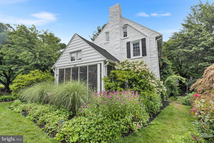 Nestled on one of Wynnewoods's most sought-after streets, this classic stone colonial exudes timeless charm while offering modern conveniences. Step into a bright and inviting foyer showcasing beautiful wood floors that flow into a large living room with a gorgeous fireplace, lots of windows offering natural light and an entrance to a most delightful screened-in porch perfect for dining al-fresco or cozy coffee time.   Across the foyer is a formal yet intimate dining room, spacious for large and small gathering and host both large front and back views of this gorgeous property and steps away from  a chef's eat-in kitchen, which is equipped with modern appliances, fabulous counter space, custom cabinetry and steps out to an amazing yard and gardens. A detached one-car garage with an electric car charger is steps from the kitchen entrance. A discretely situated spacious first floor half bath completes the first floor. Ascend the stunning staircase, adorned by a landing with a gorgeous custom picture window as you enter the beautiful primary suite showcasing a newly renovated custom tile shower and vanity, beautiful tile floors, large walk in closets and so much more.There are two addtional bedrooms, both spacious and bright and share a newly renovated hall bath. The third floor host two addtional bedrooms with wood floors, an abundance of windows and natural light and a share the third full bath. 
The lower level is fabulous space with a den, laundry room and exercise space that leads to bilco doors that lead to the back of the house.  There is also an unfinished side offering storage and a work bench area.
The yard and outside space is absolutely stunning and  showcase the most amazing perennial gardens and custom landscaping worthy of Longwood Gardens! Walk to everything including the both Wynnewood and Ardmore trains, Suburban Square, fabulous restaurants and shopping, parks, minutes to Lankenau and Bryn Mawr Hospital, PHl and everything the Main Line offers. Situated in award recognized Lower Merion School District.  Welcome Home!