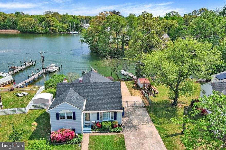 A rare waterfront opportunity where unforgettable memories have been made hosting holidays, birthdays, weddings, and summer gatherings with family and friends along the scenic shores of Rock Creek just off the iconic Chesapeake Bay. Major system updates provide added peace of mind, including a new roof installed in 2026 and HVAC replaced in 2025. 

This charming three bedroom home, with potential for a fourth bedroom, sits quietly on the water offering peace, privacy, and stunning natural surroundings. Enjoy a coffee during tranquil mornings on the spacious deck overlooking the creek as the sun rises.

Boater's dream with 5-6 feet mean water,  78' of bulkheaded shoreline, and a private pier rebuilt in 2017 which features electric, plumbing, kayak/canoe storage, a 2018 installed 12.5K lb lift, and an additional slip designed to accommodate a wide beam vessel.

Inside, recently refinished floors create a fresh and inviting feel. The grand Florida sunroom is a true centerpiece, featuring vaulted ceilings, a cozy wood burning fireplace, and three large French glass doors that frame the scenic waterfront and provide seamless access to the oversized deck. Beautiful eastern sunrise light fills the space, creating a warm and welcoming atmosphere perfect for relaxing or entertaining. The kitchen features elegant cabinetry, granite countertops, stainless steel appliances, and a gas stove, with excellent potential to expand and open into the sunroom for a more modern and connected layout. The main level also includes a spacious living room with a large bay window that enhances the natural light throughout.

Upstairs offers three generously sized bedrooms and a recently remodeled full bathroom completed in 2026. here is also an opportunity to add a private primary bathroom to further enhance the upper level. The lower level includes a versatile flex room ideal for a fourth bedroom, office, or playroom, along with a fully renovated bathroom and laundry area featuring a walk in shower.

The exterior offers exceptional flexibility with a large driveway that can accommodate boats, trailers, campers, or multiple vehicles. There is also potential to build a garage with additional living space above, buyers to verify with the county, and the property is already connected to public water and sewer which simplifies future expansion.

Perfectly located, this home has convenient access to Annapolis, Baltimore,  DC. With endless restaurants nearby both from land & sea! 

If you are VA Eligible Buyer,  financial advantage available with a VA assumable loan at 3.25% with an approximate remaining balance of $470,000.

A truly special waterfront property offering lifestyle, flexibility, and long term potential.