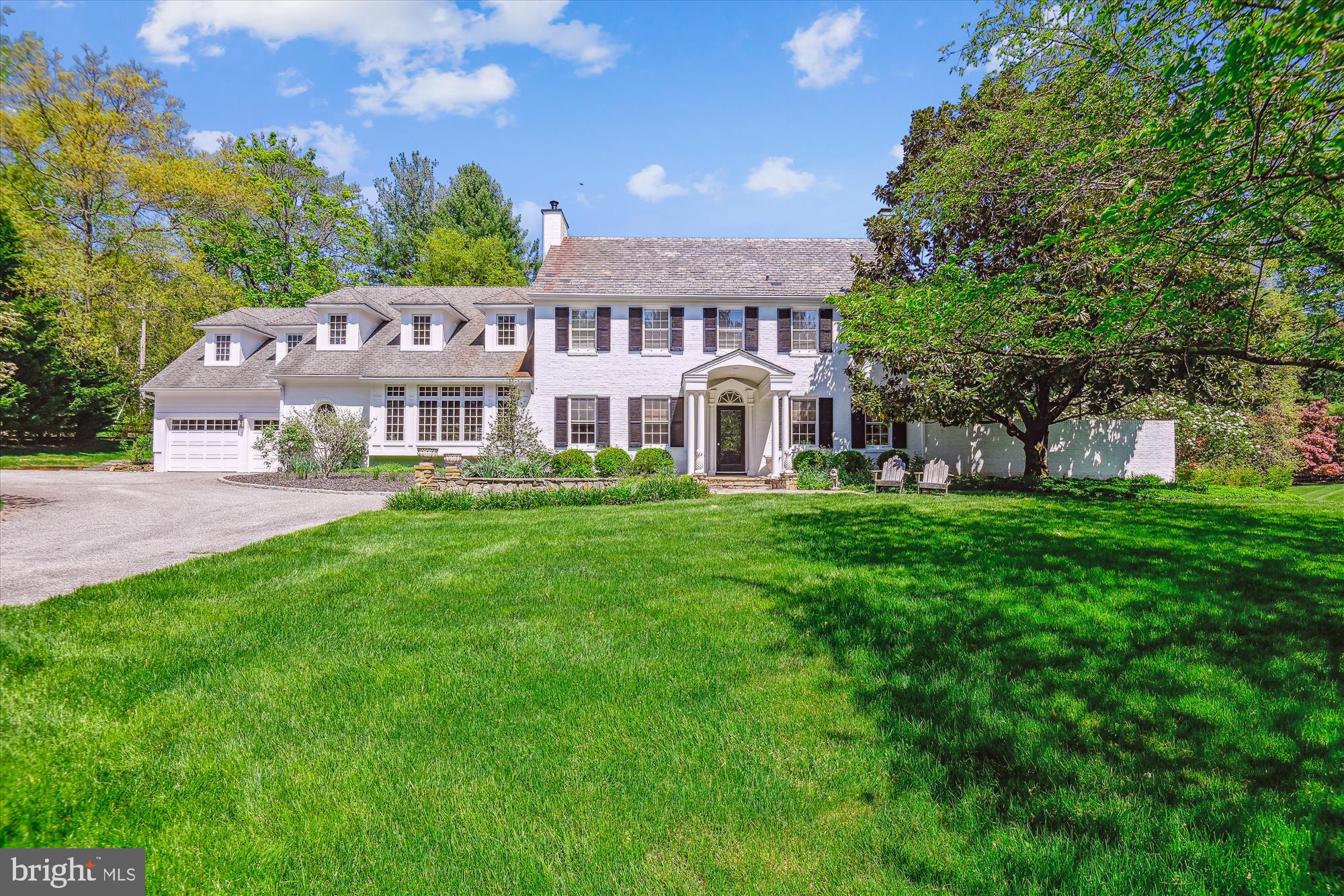 This updated home in Greenspring Valley is stunning! It seamlessly blends the charm of a traditional home with modern conveniences and updates, creating a truly spectacular living space. With five bedrooms, five full bathrooms, and two half bathrooms, there is plenty of room for comfortable living that marries functionality and sophistication. The gracious foyer sets the tone with hardwood floors and detailed molding, welcoming you into the home's elegant atmosphere. The formal living room is magnificent, especially with its fireplace and access to the “moon garden” – a private courtyard oasis with a water feature and outdoor gas fireplace. A formal dining room is offset by a divine butler’s pantry. Together, they offer perfect, flowing space for hosting gatherings and entertaining guests.
Dreams come true in this updated kitchen. Featuring an expansive center island, marble countertops, and a glorious large window that floods the space with natural light. The adjoining family room, with a dramatic and gorgeous fireplace, creates a cozy yet refined ambiance. Convenience is key with main level laundry and a huge mudroom connecting to the attached two-car garage. Ascend to the second level and be mesmerized by the primary suite; it’s complete with two individual primary bathrooms, walk-in closets and glorious natural light. Three more bedrooms and two full bathrooms on this level offer ample space for family and guests. The third level provides additional living space with another bedroom, sitting room, and full bathroom - it is a perfect get-away for the individual that needs quiet and serenity. The basement offers recreation space and ample storage room, completing the home's functionality. Outside, over two acres of flat yard offers endless space to enjoy the beautiful surroundings, with lovely patios and plantings enhancing the outdoor experience. The large greenhouse, while in need of repair, adds a classic and charming touch to the property. This magnificent home has all the bells and whistles, blending modern and traditional details seamlessly. It's truly a masterpiece of design and comfort.
