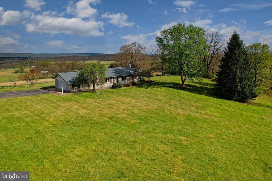 Hello, views! Hello, 7977 Knobley Road!

Welcome to this 3-bedroom, 3 full bath ranch perfectly perched on 3.74 acres, featuring breathtaking, panoramic views from its elevated setting. With over 3,000 square feet of finished living space, this home combines comfort, space, and scenery in one exceptional package.

The mostly brick exterior paired with a tile roof offers classic curb appeal and lasting durability, while the expansive paved driveway and 2-car attached garage ensure ample parking and convenience. Inside, you’ll find a spacious and well-designed layout ideal for both everyday living and entertaining.

The fully finished basement adds significant living space, featuring a cozy fireplace, wood stove, and a private sauna for a true at-home retreat. Whether you're looking for additional family space, a recreation area, or a place to unwind, this lower level delivers.

Enjoy peace of mind with a recently updated heat pump, providing efficient heating and cooling year round.

If you’ve been searching for a home that offers privacy, space, and truly incredible views, this property is a rare opportunity you won’t want to miss.