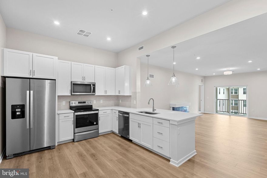 **FINAL HOMES** NEW CONSTRUCTION / 55+ COMMUNITY Special all-in price! Aspen home for immediate move-in. This 4th-floor home (top floor) has two bedrooms & two bath with southeast views. Hosting friends is ideal in your open-concept living and dining room. Adjacent to the kitchen with the large pantry, you'll find a flex space that you can transform into your own expansive living and dining room or a place for your favorite hobbies. Relax and unwind in your spacious primary bathroom, equipped with an oversized shower; dual closets for your comfort. Plus, enjoy a covered deck perfect for unwinding or gathering with loved ones. Blinds are included on all windows. Revel in a resort-like getaway every day in the Aspen. Dedicated covered parking space and storage unit included. **OPEN 10 AM – 5 PM, Thurs-Sun, By Appointment Only Tues-Wednesday** Receive 1 Year Paid of Condo Fees* and $12K* in Closing Costs Until 12/17!* See New Home Counselor for Details. Gatherings® at Potomac Station offers 55+ living near Leesburg’s vibrant dining, live music, and art scene. Enjoy green spaces like Ida Lee Park, top healthcare at Inova Loudoun, and easy access to shops, trails, and cultural events. This vibrant community includes a private fitness center & yoga studio and a center courtyard with walking path. Perfect for an active lifestyle! With low-maintenance design and fewer common repairs, you’ll spend less time on upkeep and more time enjoying the comfort of home. Enjoy a life free of yardwork or shoveling. Landscaping and upkeep are handled for you, so you can spend your time how you want to. Look for parking along California Avenue near the paved steps/ramp between the main buildings. Follow the signs and take the steps or ramp to our building entrance. Please use keypad to call our 2nd-floor SALES OFFICE.