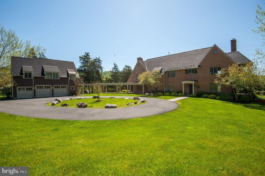 Please see Matterport under Virtual Tour. Exceptional Country Estate w/ Deluxe Detached Home Office (or In - Law Apartment) in Furnace Mountain Estates just 10 minutes to the MARC train to Washington DC and 25 minutes to historic Leesburg.  Paved roads lead to this magnificent custom home (first time offering) sited on 13.90 scenic acres.  After a long and dedicated search, the owners selected this parcel because it reminded them of an area at the base of the Alps in Switzerland with all of the characteristics they desired: open pastures, mountain views and water elements.  With the help of a skilled architect and renowned LOCO Builder, Dale Schultz, they set out to create a home "like no other" with an emphasis on joining the home harmoniously with the land so that the two would complement each other. From the numerous terraces and balconies, the peaceful calls of waterfowl can be heard as they skim across the pond and year-round views of the always changing yet ever majestic Furnace Mountain can be seen.  The land is a combination of rolling and level topography with striking comparisons from the manicured and landscaped front entry to the magical and wild woods where deer trails traverse a bold stream sheltered by a canopy of towering trees.  Totally unique in design, the home exudes the elegance of a true European country chateaux.  Accessed by a circular drive and crowned by the grand pergola that connects the Detached Garage with Office to the Main House, the home quietly stands before you.  An understated front door opens to a home that is both impressive and comfortable.  Enter at the two -story foyer where the soft hues of earth tone tile and wrought iron balusters dress the entry and from here the home opens to multiple areas to entertain or just enjoy everyday life.  Each room is a unique experience -unpredictable, refreshing and memorable.  The Dining Room's French doors open to the rear terrace and sweeping lawn.  Evening dinners are accentuated by fireflies and the chorus of frogs in the pond.  In wintertime, there's no place like the main floor Library where wood crackles in the fireplace. In milder months, the Library French doors open to take in southwestern breezes and join a covered flagstone porch.  On the opposite side of the home, the Kitchen is brilliantly oriented so the chef can enjoy conversation w/ guests seated at the raised island and feel the warmth of the fireplace from the adjoining Family Room.  A spacious window nook with seat holds your large farm table but many months of the year you're likely to be enjoying breakfast and dinner on the east terrace watching the ducks paddle the pond.  Upstairs an atrium landing delivers four bedrooms, three full baths, the laundry and... the balconies! The Primary Suite is a respite with a wood burning fireplace, a recessed office area with sensational views, a large walk- in closet and dressing area. The Primary Bath has a center jetted tub and deep 2 person walk -in shower.  And the Primary balcony is simply incredible - with views of nature's splendor all day and amazing star gazing at night.  An En-suite bedroom is ideal for guests and two additional bedrooms share a spacious Jack-n- Jill Bath. Be sure to see the alcove in Bedroom four with an enormous window seat for afternoon dreaming.  Back on the main level, a side hall leads to the covered pergola with flagstone walk leading to the 3 car-detached garage and private office suite featuring a large great room which easily serves as a professional sized office, a kitchenette, full bath and an additional bedroom.   Additional opportunity to expand in the large unfinished walk out basement. THIS PROPERTY IS A TRIUMPH- elegant yet fun, spacious yet manageable.  Year round living or a weekender close to the MARC train to DC. The perfect palate -build a horse barn, grow grapes, try your hand at cattle or just simply enjoy as it is today.  Please see extensive recent upgrades in documents section.