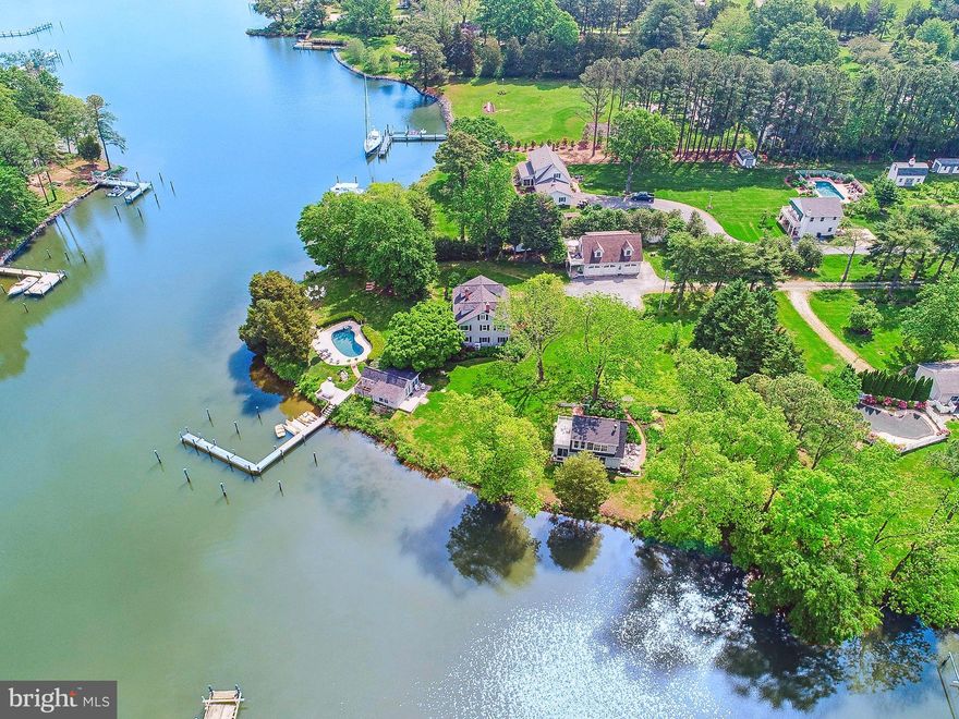 Welcome to Ships Cove, an exceptional, absolutely charming, romantic waterfront property located less than a mile by land or sea, from historic St. Michaels! The recently renovated property consists of 4 buildings that include a main house with 6 bedrooms and 5.5 bathrooms, a 2 bedroom/2 bath guest house, 2 luxury bedroom and bath suites above a 3 car garage, a pool/boat/game house with full bath, a waterside pool with gorgeous views down Long Haul Creek past the Miles River Yacht Club to the Miles River. Beautiful, elevated point of land with a much sought after, deep water, multi-slip pier. Enjoy the casual elegance of the Eastern Shore lifestyle with features like balconies, decks, outdoor shower, fire pit & outdoor dining area. Mature trees & landscaping bring seasonal beauty throughout the year. Perfect for a family compound. Ships Cove also has a 12 person Short Term Rental License. Offered fully furnished. Settlement to take place after Labor Day 2024. Restricted showing times due to summer rentals. Contact listing agent for details. This one of a kind property must be seen to be appreciated!