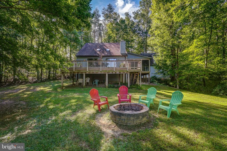 You'll love this Lake Anna retreat with huge views located on the public side of the lake! Turn key and comes furnished so you can enjoy the lake right away. High Speed Xfinity Comcast internet is available here. Great investment opportunity to own this waterfront retreat that offers 3 bedrooms, 2 full baths and an oversized 2 car detached garage that has a finished living quarters above complete with a full bath, making it the perfect getaway for you and your family to relax and unwind in separate spaces. The main home has an open floor plan featuring a kitchen with new stainless appliances, dining area and a family room with vaulted wood ceilings and sliding doors to the large back deck that has composite decking. Main level primary bedroom and a full bath. The second level features 2 bedrooms and a jack n' jill full bath.  Beautiful screened porch with tongue and groove ceilings is the perfect place to enjoy outdoor dining while taking in the views and calming privacy.  Enjoy evenings by the fire pit or sunny days by taking a stroll down a path to your waterfront area that has a small covered dock with a battery lift (great for a jet ski or or small fishing boat) or check out YOUR BRAND NEW DEEP WATER shared covered dock that has a 60 year lease and was just completed and payed for this month by the current owner and one other neighbor in the common area (perfect for your big boat). This home is currently a vacation rental and any rentals already booked convey to the new owner at settlement and must be honored by the new owner.  Great lake location just minutes by water to the Cove restaurant, Tim's at Lake Anna, Below Deck LKA, mini golf, MooTru Ice cream, and just a short drive to grocery shopping, Lake Anna Taphouse and other local wineries and breweries. Come enjoy the lake life and explore everything that beautiful Lake Anna has to offer. Just grab your friends, family and your swimsuit & let your stress drift away!
** New covered shared boathouse 2022, all new appliances 2020, garage built 2016**