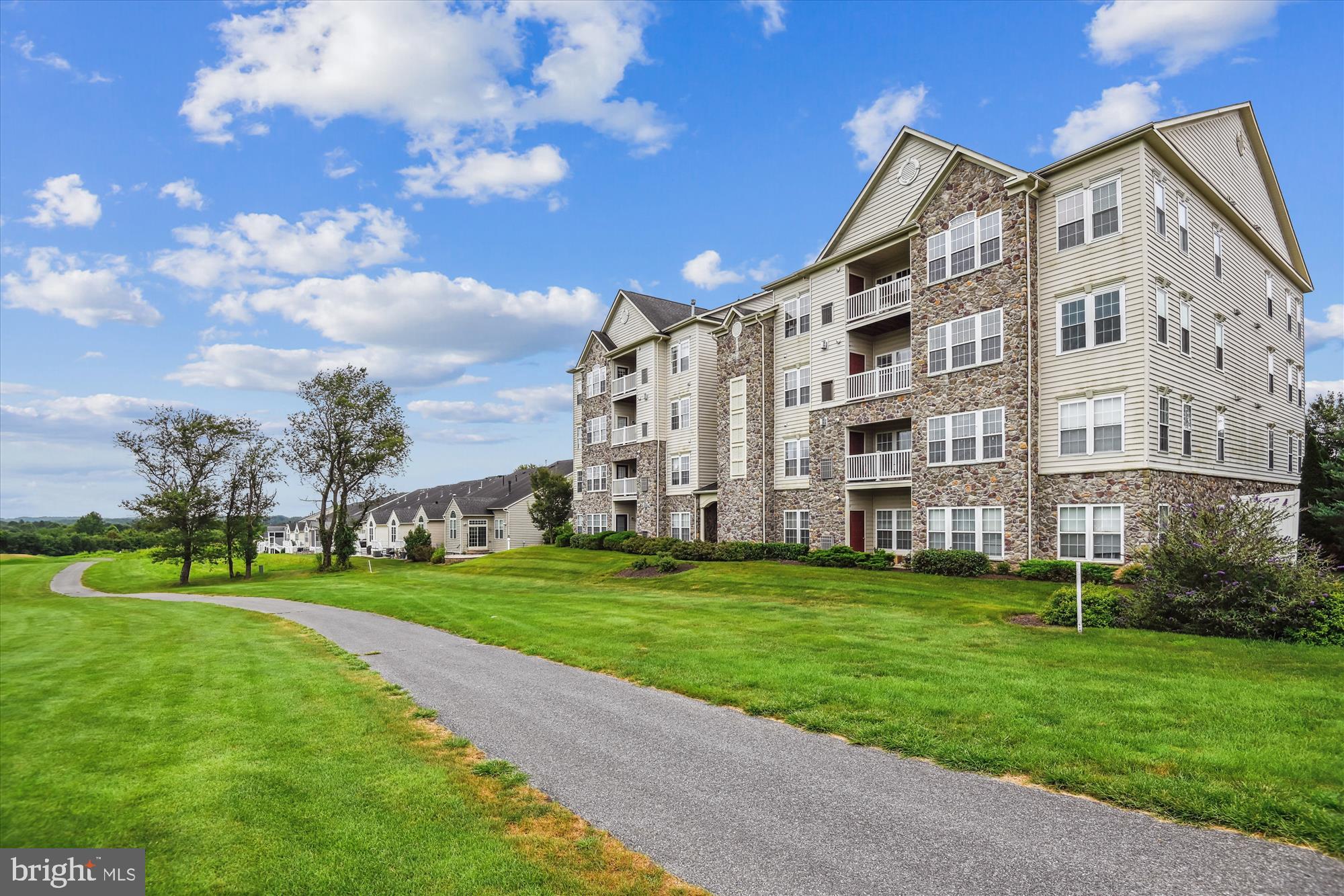 A Must See - move-in condition! Step into the highly sought-after 55+ community of Courtyards at Waverly Woods East, where comfort, convenience, and a vibrant lifestyle await. This sunny garden style condo with Golf Course views welcomes you with a secure-entry and elevator to the third level. The original owner has beautifully cared for this home. Its pride in ownership is evident from the minute you step inside. HVAC 2024 - Washer/Dryer 2023 and more!
Enjoy over 1,610 square feet of beautifully designed living space, where every detail is meant to make you feel at home. From the moment you enter, the foyer—with hardwood floors and two closets—offers both style and convenience. The spacious living room, anchored by a cozy fireplace, invites relaxation, while the separate dining room is ideal for hosting family and friends. The kitchen shines with stainless steel appliances, ample cabinetry, hardwood floors, Corin counters, a pantry, and direct access to the breakfast room and private balcony—perfect for morning coffee or evening unwinding. The oversized primary suite is a true retreat, featuring a comfortable sitting area, a huge walk-in closet, and a spa-like bath with dual sinks, a walk-in shower, and a linen closet. A versatile second bedroom, an additional full bath, and a dedicated laundry provide comfort and functionality for everyday living.
 Enjoy the outdoors on your private composite wood balcony—building backs to the Waverly Woods Golf Course with beautiful views. The resort-style amenities include the clubhouse, scenic walking trails, charming gazebos, refreshing pools, tot lot, tennis courts, pickleball court, bocce ball, and more—perfect for warm days and connecting with neighbors. For golf enthusiasts, the nearby Waverly Woods Golf Club offers memberships for an additional fee.
Welcome Home!