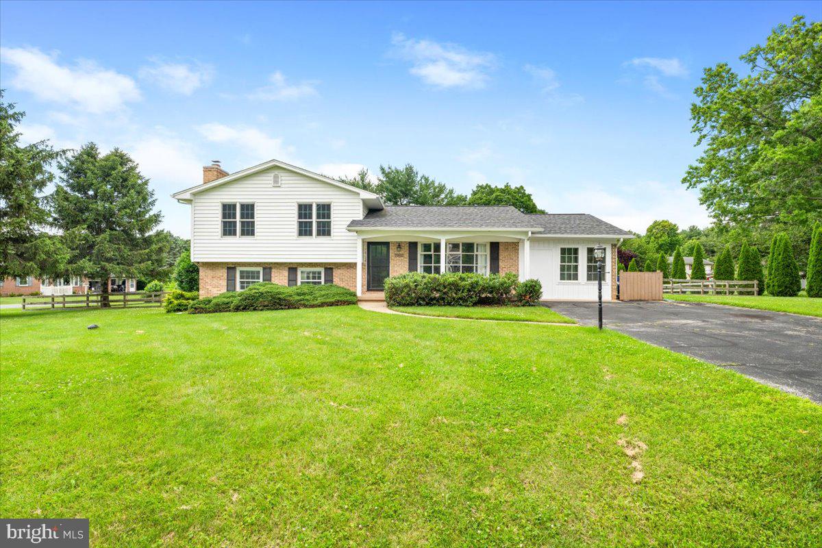 Huge price improvement makes this an even better opportunity!! Welcome to this stunning split-level residence, quietly nestled on a spacious corner lot in the desirable West Hill community—a neighborhood with no HOA or city taxes, and access to Clover Hill amenities! Enjoy convenince to downtown Frederick, Fort Detrick, and local attractions without city tax. As you approach, you’ll be greeted by a charming covered front porch that invites you inside. Step through the front door and immediately notice the gleaming hardwood floors and open-concept living space, perfect for modern living. The current owners have thoughtfully expanded the main level by converting the former garage into a bright and spacious bonus area—ideal for entertaining, relaxing, or working from home. The kitchen is a true centerpiece, featuring granite countertops, a center island, stylish backsplash, and soft-close cabinetry. Step out from the kitchen into the fully fenced backyard, complete with a large patio, pergola, and ample space to enjoy outdoor gatherings, gardening, or quiet evenings under the stars. Upstairs, the primary bedroom offers a tranquil retreat with views of the backyard and a private en-suite bath. Two additional generously sized bedrooms share a full bath adorned with ceramic tile, dual granite vanities, and abundant space. The lower level offers even more living area, complete with a cozy stone wood-burning fireplace, perfect for a rec room, family room, or playroom. A full bathroom on this level adds convenience, along with ample storage and laundry space. Enjoy a large, flat backyard and a prime location with easy access to Wegmans, Fort Detrick, downtown Frederick, parks, hiking trails, and commuter routes. This move-in-ready home combines comfort, space, and location— truly a rare find!