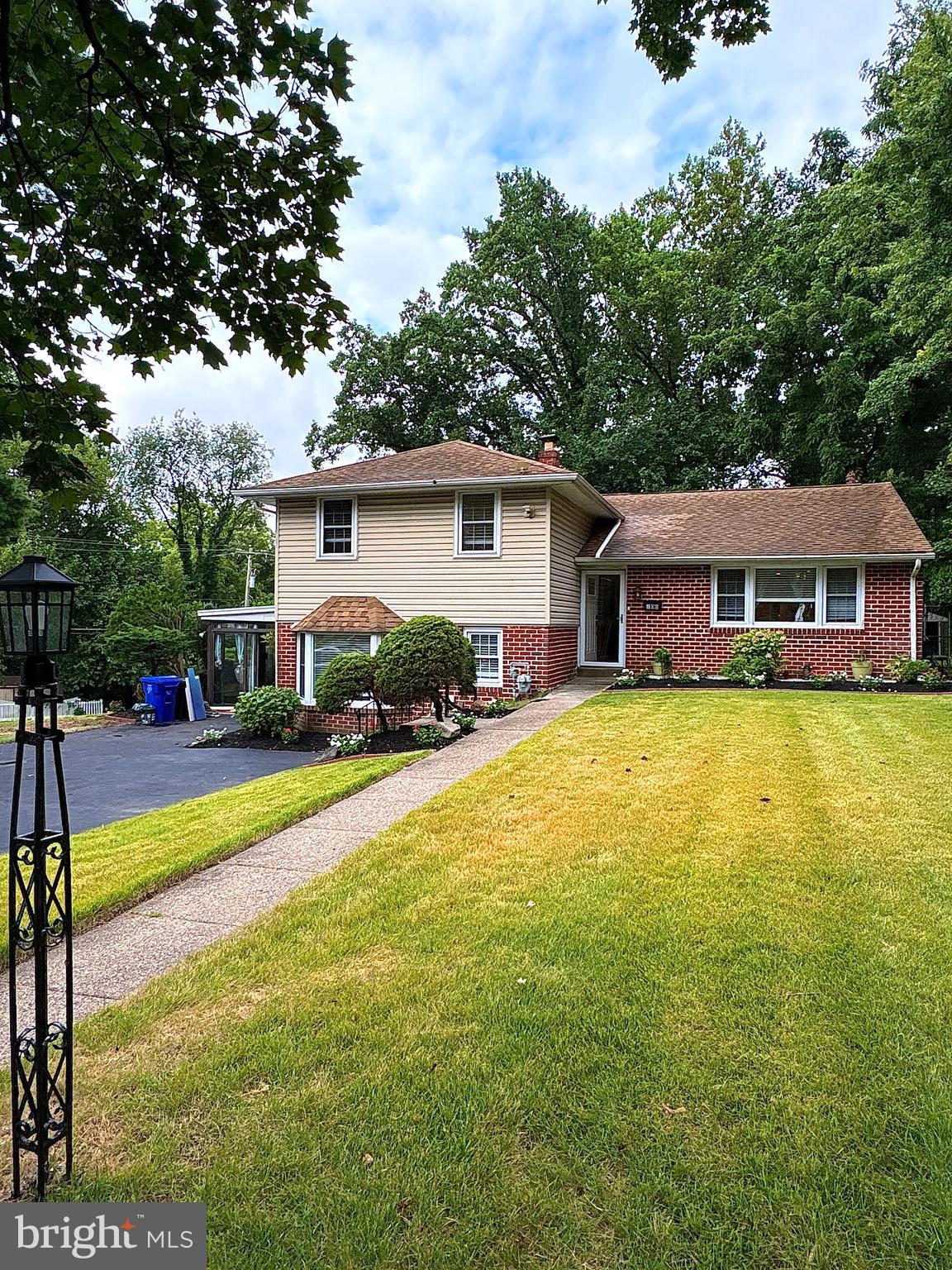 Nice corner property .Welcome to an updated and well maintained split level home in a serene neighborhood close to local shops, parks ,schools and the City. Enter to find beautiful wide plank Engineer flooring and fresh paint throughout the home. Abundance of natural light and recessed fixtures guide your way in this open floor plan. Kitchen has classic raised oak cabinetry, granite counters, subway tile back splash, and modern appliances . Entertain in the family room with a wood burning stone fireplace for cozy atmosphere or step into the large glass enclosed sunroom through the sliding door for covered outdoor experience. Bathrooms are updated with gorgeous tile work and accented with quartz top and modern fixtures. Garage has been converted for extra living space but, there is plenty of parking in the large driveway. Roof was replaced in 2012. Enjoy all indoor comforts with energy efficient insulated windows or step outside to the large deck to take in the beautiful views of the tree lined scenic back yard. All offers will be review.