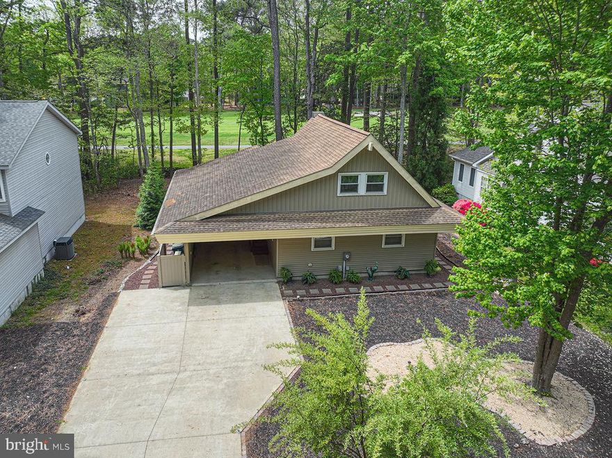 Beautifully updated and truly unique Chalet-style home offering 3 bedrooms and 2 full baths, perfectly situated on the 4th hole of the prestigious Robert Trent Jones Sr.–designed golf course in Ocean Pines—just minutes from the beaches of Ocean City, MD. This lovingly maintained home has been extensively renovated over the past four years with a focus on comfort, efficiency, and modern style. The interior features new luxury vinyl plank flooring on the main level, brand-new wall-to-wall carpet upstairs and on the stairs, fresh paint and caulking throughout, new 6-panel interior and closet doors, updated baseboard trim, and stylish new light fixtures. A sleek electric fireplace adds warmth and charm to the living space.
The kitchen is fully updated with a complete suite of new stainless steel appliances, along with a convenient stackable front-load washer and dryer. Both bathrooms have been refreshed with new toilets, while additional improvements include all-new double-pane windows with plantation blinds and new front and rear exterior doors. Major system upgrades provide peace of mind, including a new HVAC heat pump, Mitsubishi mini-split system for the second floor, new hot water heater, and a whole-home water filtration system. Upstairs easements have been insulated and floored, enhancing both energy efficiency and storage capacity. Step outside to enjoy a host of exterior upgrades, including a new deck, new scalloped fence (2025), new cement driveway, new concrete carport floor, and a beautifully landscaped perimeter walkway (2025). The home also features 6-inch gutters with leaf guards, professionally trimmed trees, and an enclosed entryway leading to the screened porch for added usability. With its prime golf course location and extensive upgrades throughout, this move-in ready home offers exceptional value in one of the area’s most desirable communities. Aggressively priced—schedule your private showing today before it’s gone