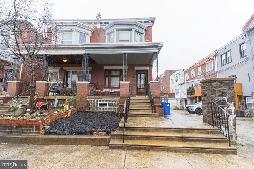 Welcome Home! This beautiful 4 bedroom, 2 bath corner twin home has it all! While preserving its historic charm, this home also offers modern conveniences to ensure comfortable living for your family. As you enter the home you are greeted by a full porch that brings you into a light filled living room with gleaming hardwood floors throughout. A spacious dining room leads you into a beautifully maintained kitchen equipped with ample cabinet space, an island bar, stainless steel appliances, and a stained glass window. As you exit the kitchen you are led into the rear driveway, with a PRIVATE PARKING SPACE underneath the 2nd story porch! Upstairs you will find 4 spacious bedrooms with ceiling fans, natural light, and plenty of room for a growing family. The primary bedroom opens up to a private 2nd story PORCH, great for morning coffee or a private outdoor getaway. The semi finished basement has a newly added full bathroom with a shower, laundry, and plenty of room for additional storage. Located on a tree lined block, this home is within an easy walk to parks, restaurants, and all that Cedar Park and University City have to offer. Plus it is in close proximity to HUP, CHOP, Penn, Drexel, St. Joseph's, and Center City. Schedule your tour today!