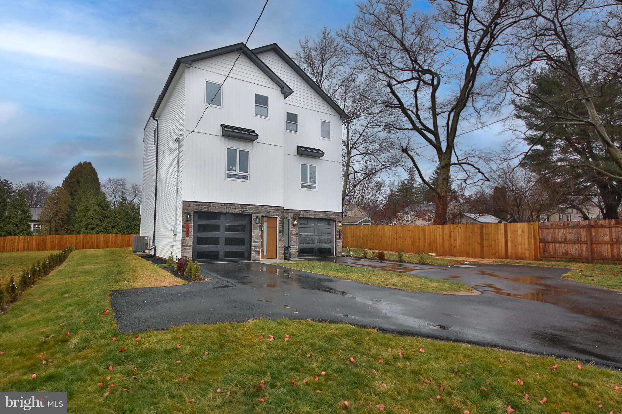 Welcome to your dream home in the heart of Glenside! This stunning new construction offers modern elegance and thoughtful design. As you enter the lower level, you'll immediately notice neutral-toned walls, and recessed lighting that create a warm and inviting ambiance. This level features a versatile office space​/ bonus room with full bathroom, ​and access to the backyard, perfect for working from home or hosting guests. The main level features hardwood floors and has an open-concept layout, seamlessly connecting the family room, dining area, and a sleek, modern kitchen, along with a powder room. The kitchen shines with white cabinetry, stainless steel appliances, and a chic tile backsplash, Sliding doors lead from the dining area to a spacious deck, ideal for outdoor entertaining. On the upper level, you'll find a luxurious primary suite complete with a walk-in closet and an en suite bathroom featuring a rainfall shower, gold accents, and wood paneling for a spa-like retreat. Two additional bedrooms share a hall bathroom, offering ample space for family or guests. This home also includes a garage and driveway Situated close to downtown Glenside and Jenkintown, you'll have easy access to vibrant shopping, dining, and entertainment options, including the Keswick Theater. Commuters will appreciate the proximity to the PA Turnpike and train stations with service to Philadelphia.
Don’t miss this incredible opportunity to own a brand-new home in an unbeatable location. Schedule your showing today!