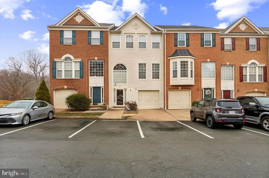 Welcome to this stunning 3-level townhome, ideally located just 5 minutes from Quantico's main gate. With its prime location near US-1 and I-95, this home offers seamless access to Washington, D.C., Stafford, Fredericksburg, and Richmond—perfect for commuters and adventurers alike.

The entry level features a carpeted recreation room, ideal for a home office, workout space, or guest area, complete with a full bathroom for added convenience.

Step up to the main level, where elegance meets functionality. Beautiful hardwood floors, crown molding, and chair rail details create a sophisticated yet inviting ambiance. The open, light-filled family room is perfect for gatherings or quiet evenings. The spacious kitchen is a home chef’s dream, with rich oak cabinets, upgraded quartz countertops, a double wall oven, and an electric cooktop. The large island provides additional prep space and storage, while the dining area leads out to a serene back deck. Overlooking trees, this peaceful space is ideal for morning coffee or unwinding after a long day. The yard below offers the perfect setup for weekend cookouts.

The upper level boasts three generously sized carpeted bedrooms. The primary suite is a true retreat, featuring a walk-in closet and a luxurious en suite bathroom with a jetted soaking tub, a separate shower, and a dual vanity. Two additional bedrooms and a hall bath with a tub complete this comfortable living space.

This townhome is nestled in a neighborhood that includes basketball courts, a dog park, and a playground, offering activities for everyone. Don't miss this opportunity to enjoy modern living with a fantastic location—schedule your visit today!
