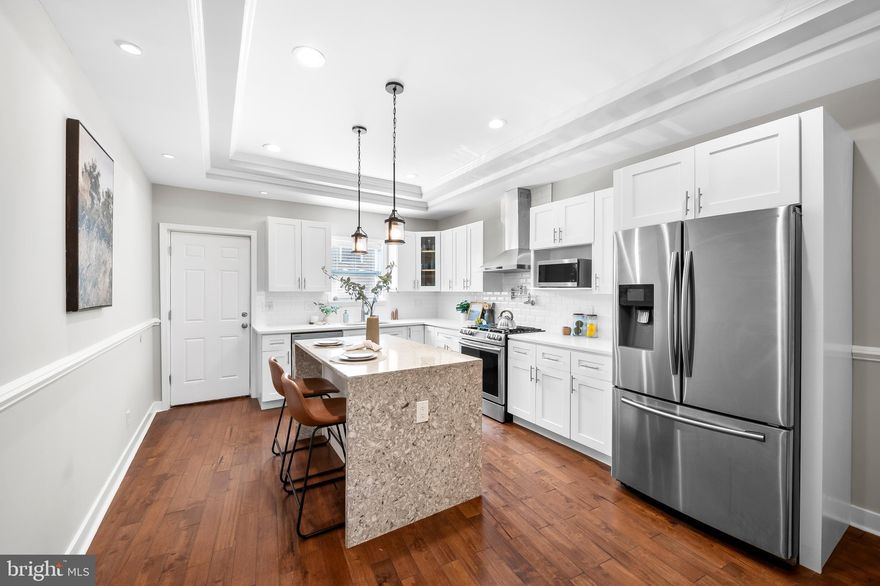 Prime 4-story Fed Hill CHAP Tax Credit property, saving you thousands for approximately 1.5 more years! (Most recent tax bill less the credit was $4,023, saving approximately $562/month or $6,744/annually. Buyer to verify time on CHAP left.) 15-ft wide home with an open main level, equipped with stunning walnut hardwood floors, powder room, large dining area, and quartz waterfall island in the kitchen. 2 bedrooms on the 2nd level, each with ensuite bathrooms. Laundry in hallway. Massive primary suite in the rear of the home with multiple closets and walk-in shower. 3rd bedroom or flex space on 3rd floor with access to recently stained rooftop deck, perfect for the 4th of July fireworks coming up! Oversized parking for 1 car in the rear of the home and easy street parking otherwise. Fully finished basement to be used as 4th bedroom, in-law suite, or a 2nd living room, equipped with a kitchenette and the 3rd full bath. Use it yourself or house hack and generate income by renting it out! (Was previously rented out for $1,200/month.) Fantastic opportunity in the heart of Federal Hill, don't miss out!